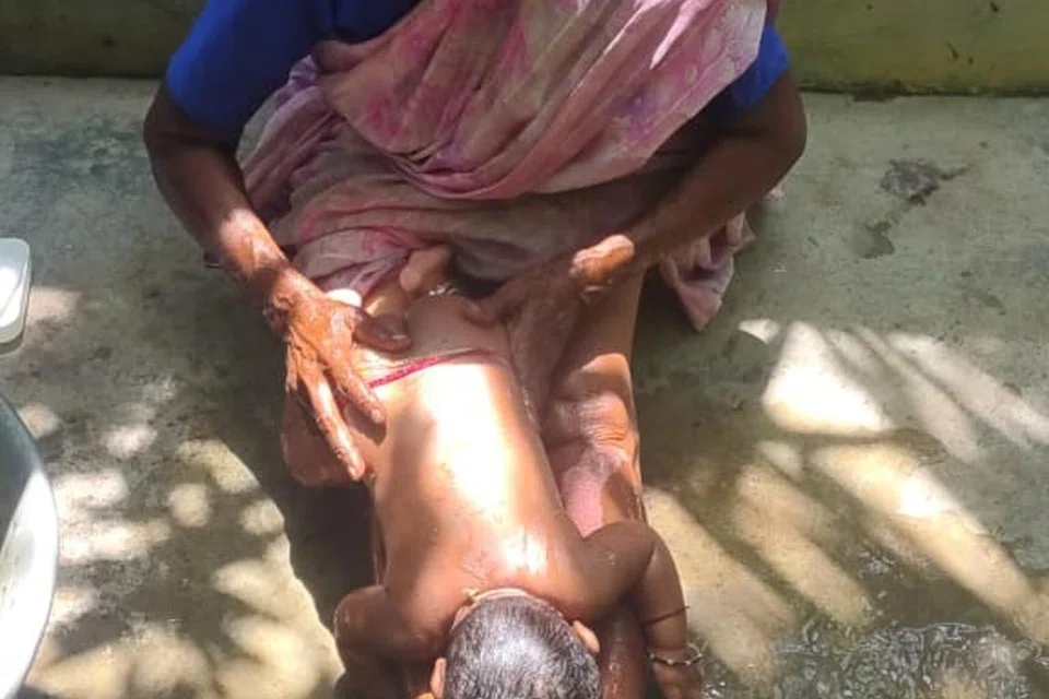 திருநாங்கூர் என்ற ஊரில் தனக்குத் தெரிந்த குடும்பத்தாரின் மூன்று மாதப் பெண் குழந்தையைக் குளிப்பாட்டிவிடும் திருவாட்டி வசந்தா. 