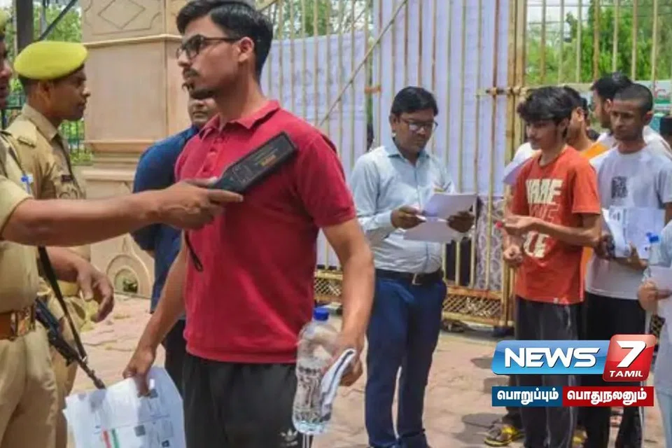 தேர்வு மையத்திற்குள் செல்வதற்கு முன் சோதனை செய்யப்படுகிறது.