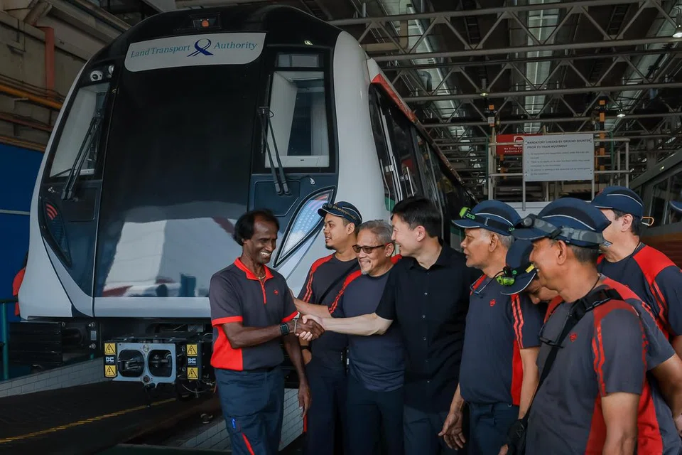 பீஷான் பணிமனையில் எஸ்எம்ஆர்டி பணியாளர்களுடன் தற்காலிக போக்குவரத்து அமைச்சர் சீ ஹொங் டாட். அவர்களின் அருகே புதிய ஆர்151 ரயில்.