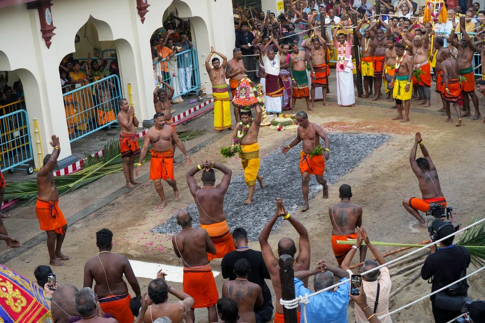 ஞாயிற்றுக்கிழமை (அக்டோபர் 12) நடைபெற்ற தீமதித் திருவிழாவில் தலைமைப் பண்டாரம் வேணுகோபால் திருநாவுக்கரசு, பூக்குழியைக் கடந்து செல்கிறார்.
