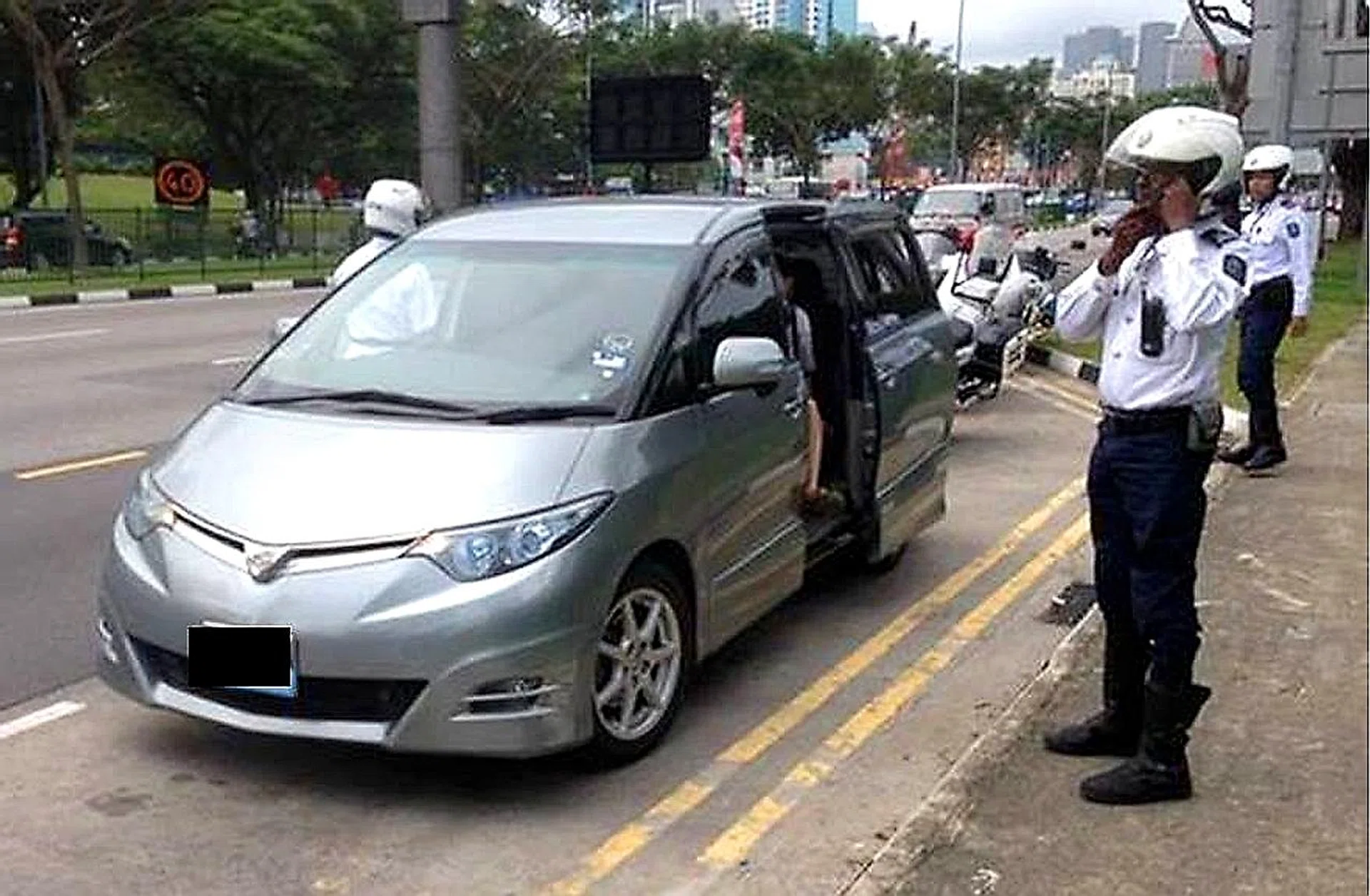 LTA officers (above) carrying out checks for unlicensed private cars and private-hire cars. 