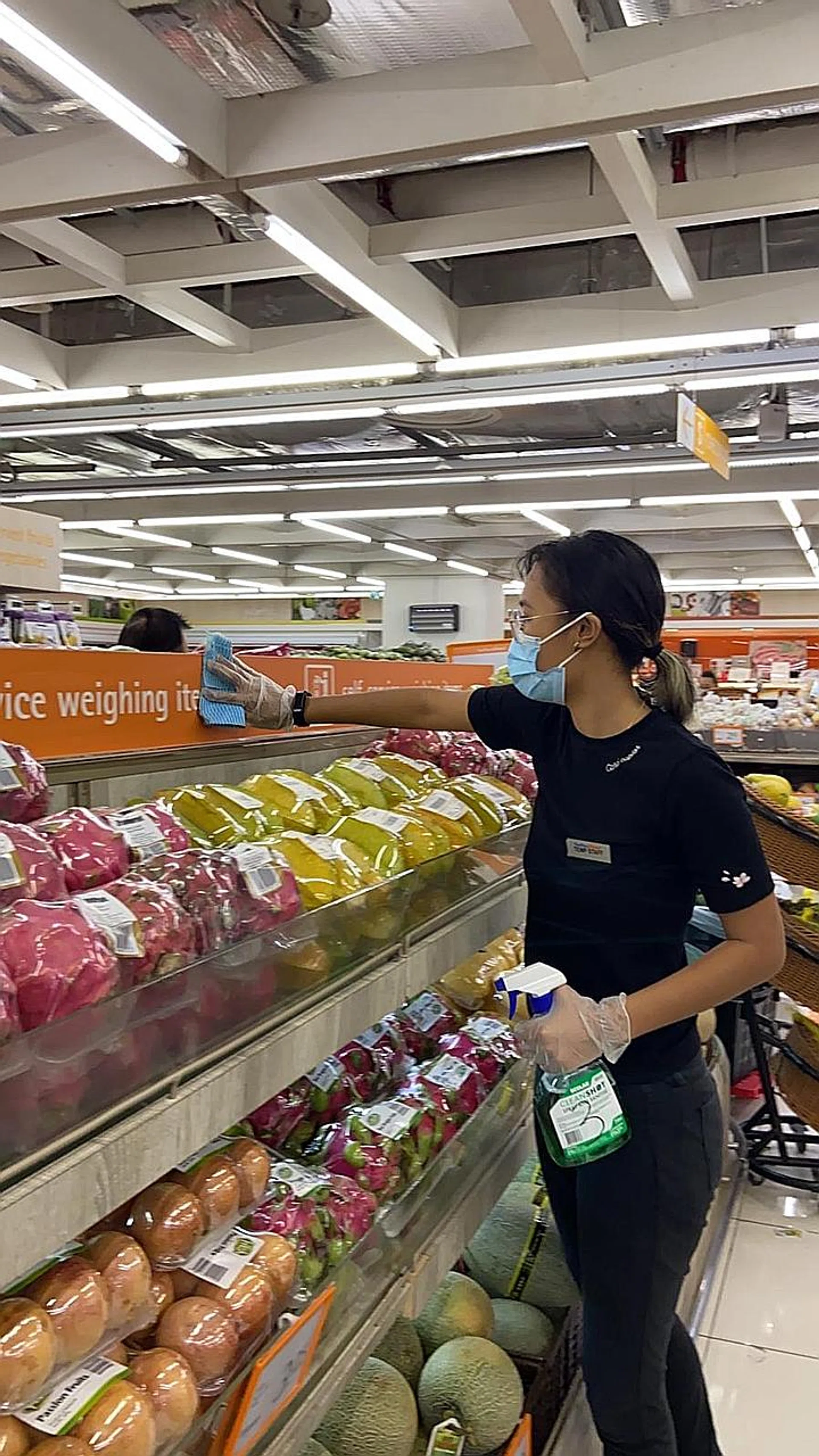 Miss Dian Afiqah Salaihuddin now works as a part-time cashier (above). 