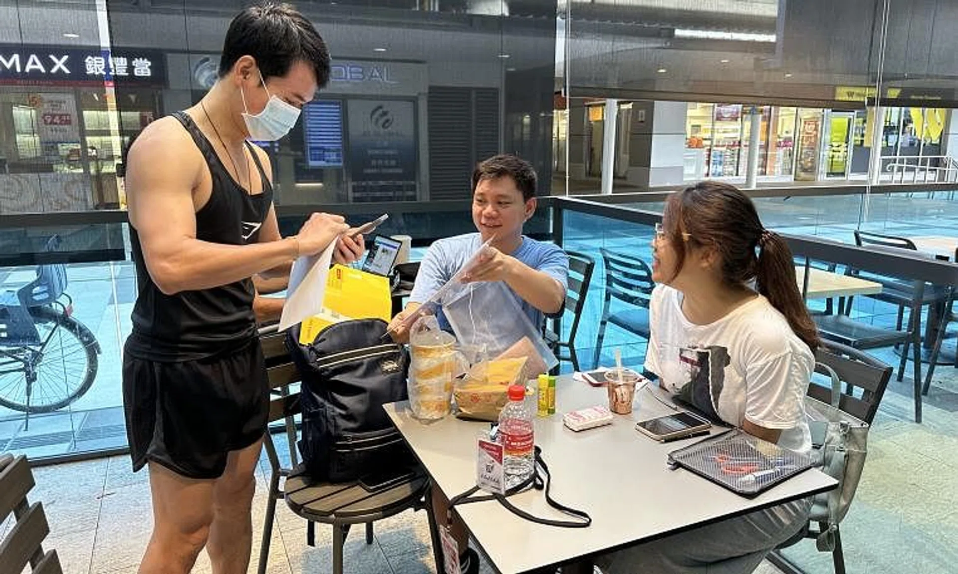 A Malaysian voter in Singapore dropping his ballot off with volunteers from 1ThirdMedia Movement at Paya Lebar Square on Aug 5. 