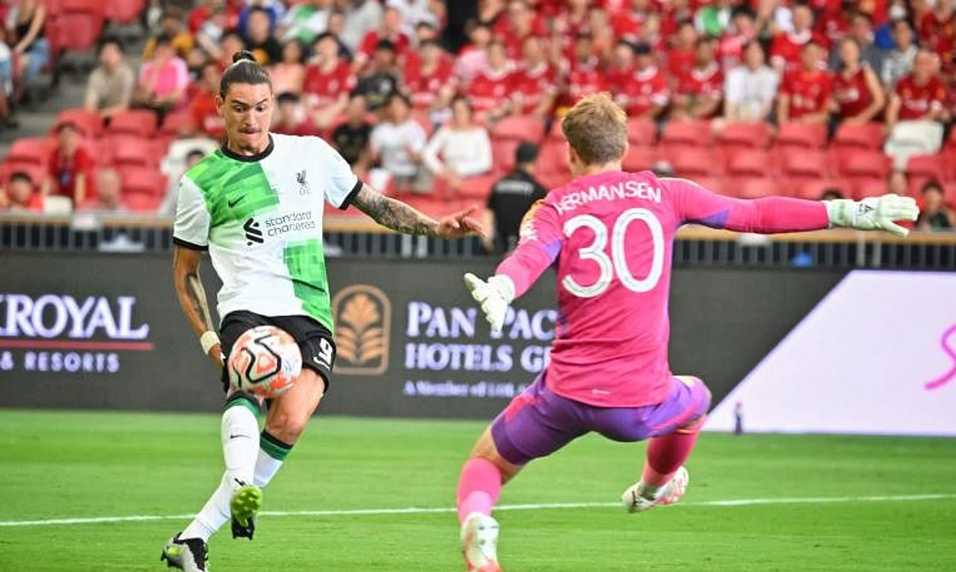 Liverpool's Darwin Nunez attempts to chip the ball past Leicester City goalkeeper Mads Hermansen at the National Stadium on July 30, 2023.