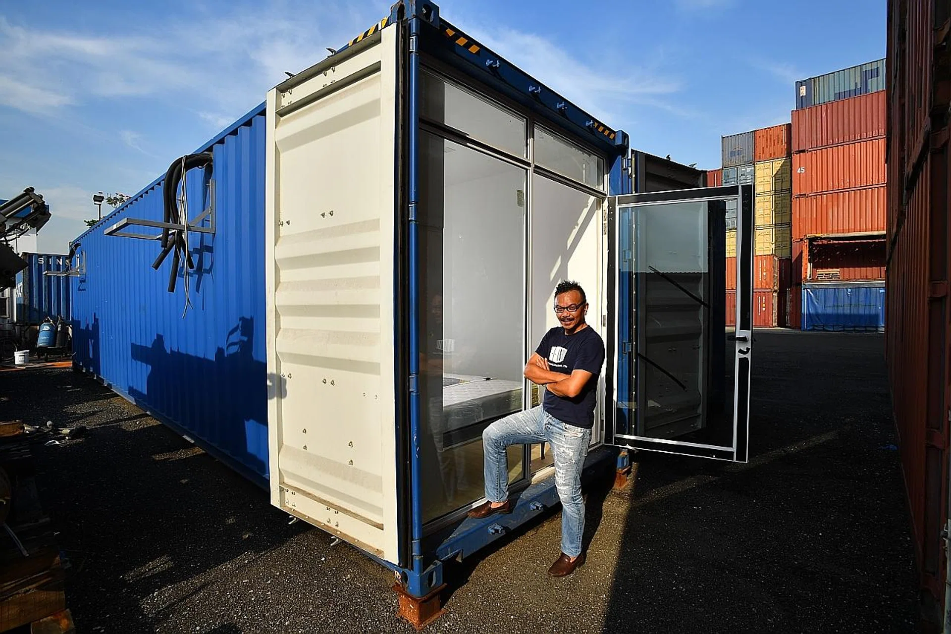 Tech entrepreneur Seah Liang Chiang (above) outside one of the container hotels. The queen-size bed and the kitchen and dining area.