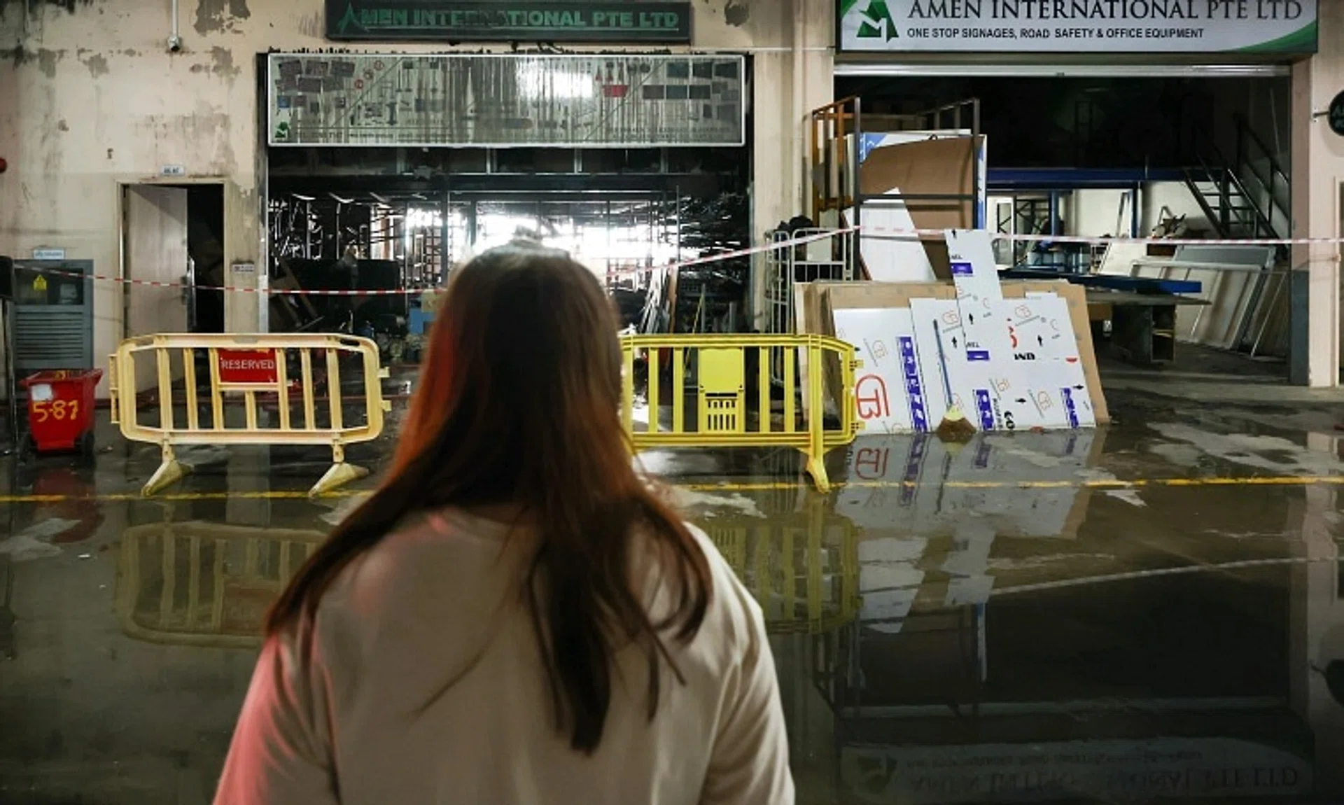 Ms Vina Tai’s car workshop is next door to a signage company that was ravaged by the blaze on Sept 19.