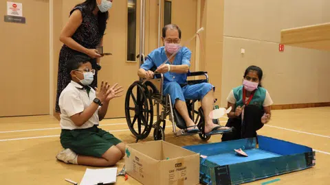 An elderly patient at Jurong Community Hospital trying out a game.
