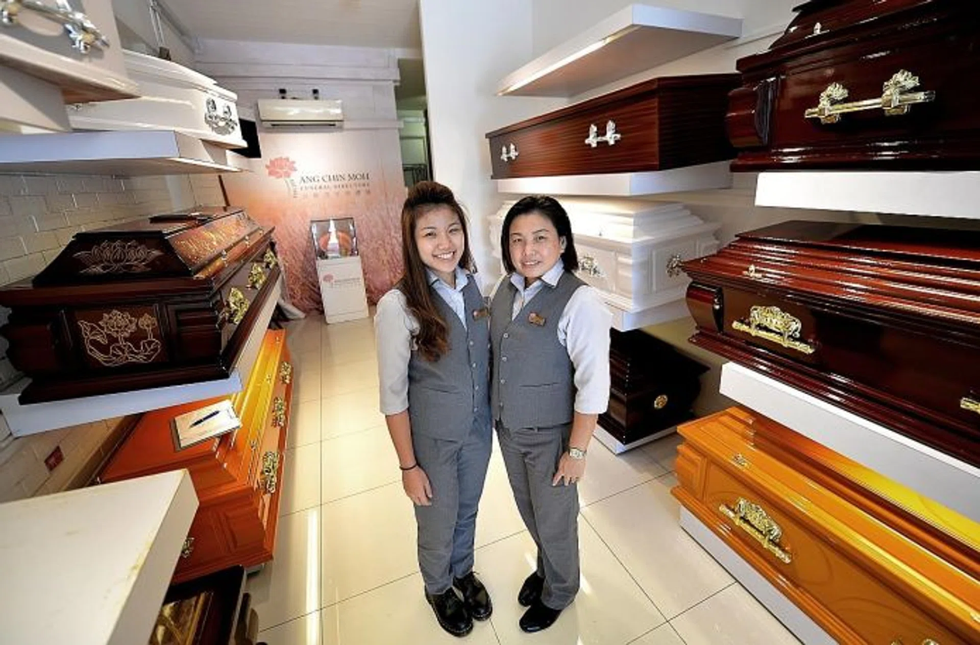 FULFILLING: (Above) Miss Joan Chan, 23, works frontline operations at Ang Chin Moh Funeral Directors while Madam Julie Tan, 45, helps to organise funerals.