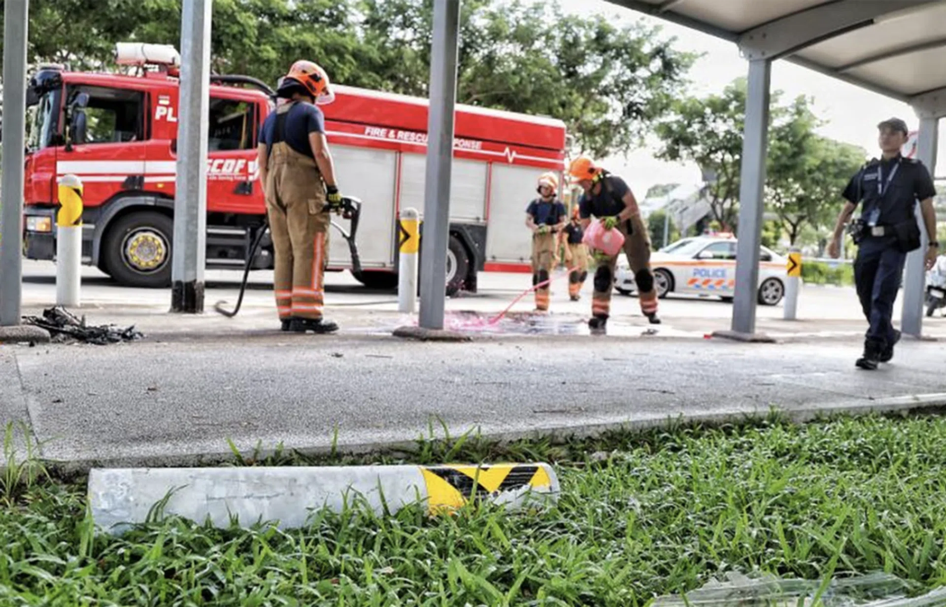 SCDF personnel cleaning up the accident site.