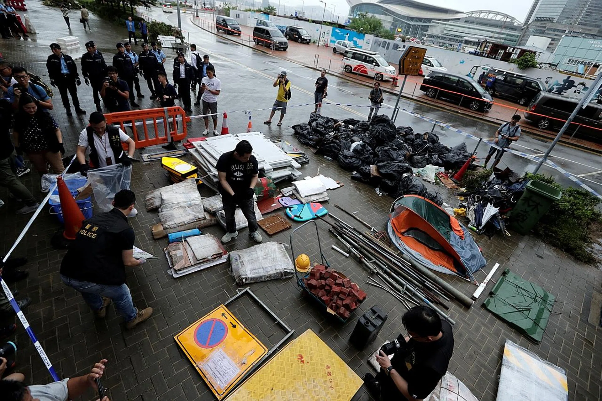 Police officers displaying objects used during a demonstration in which protesters stormed the Legislative Council building on the anniversary of Hong Kong's handover to China, outside the Legislative complex in the city. 