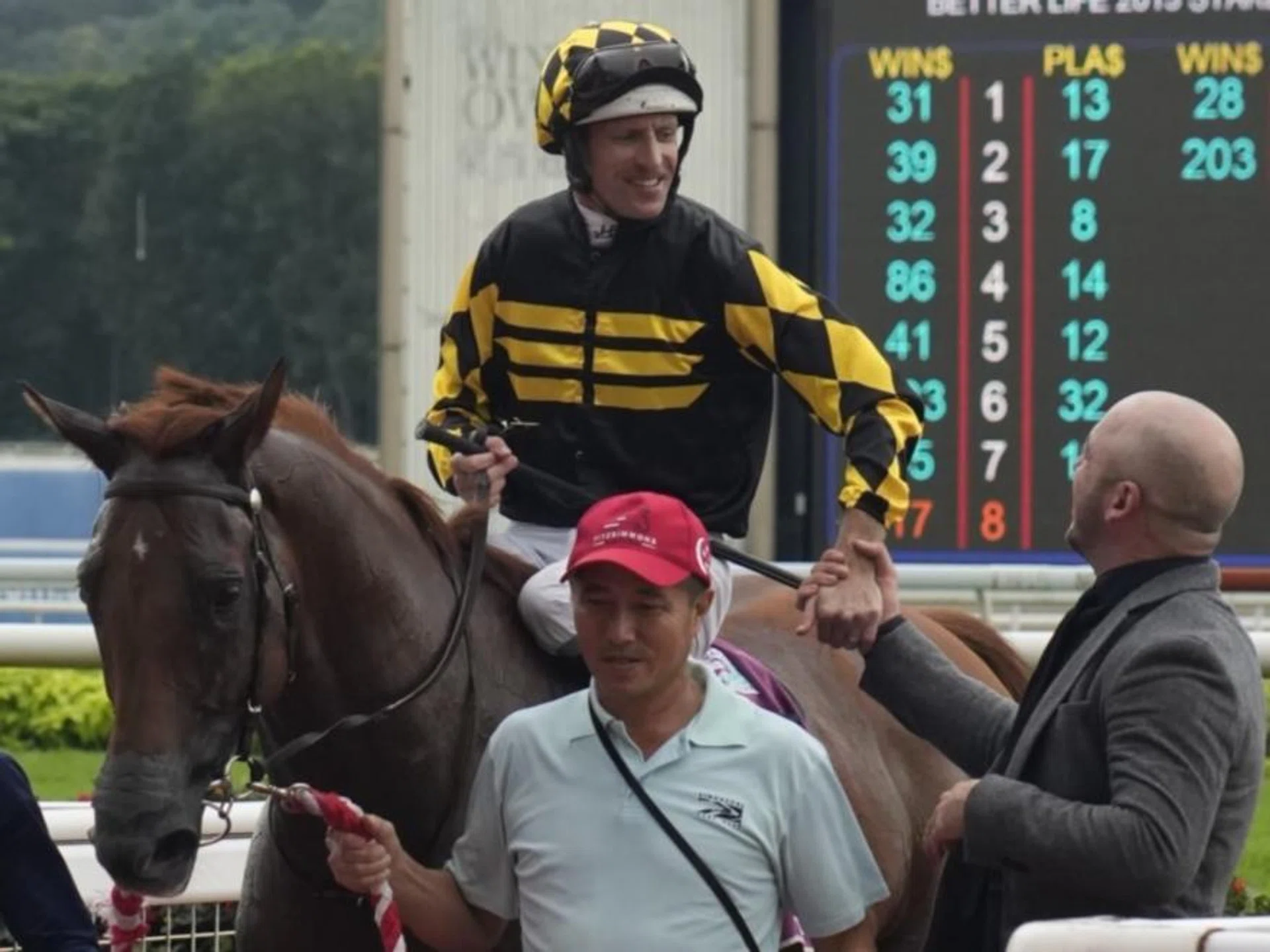 Hugh Bowman getting congratulated by Josh McLoughlan, racing manager of Jig Racing/Elvin Racing Stable after Golden Monkey's win in the Group 1 Singapore Derby (1,800m) at Kranji on July 23, 2023.