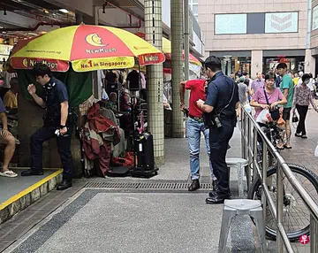 Diner telling off man smoking at food centre gets finger burnt while arguing