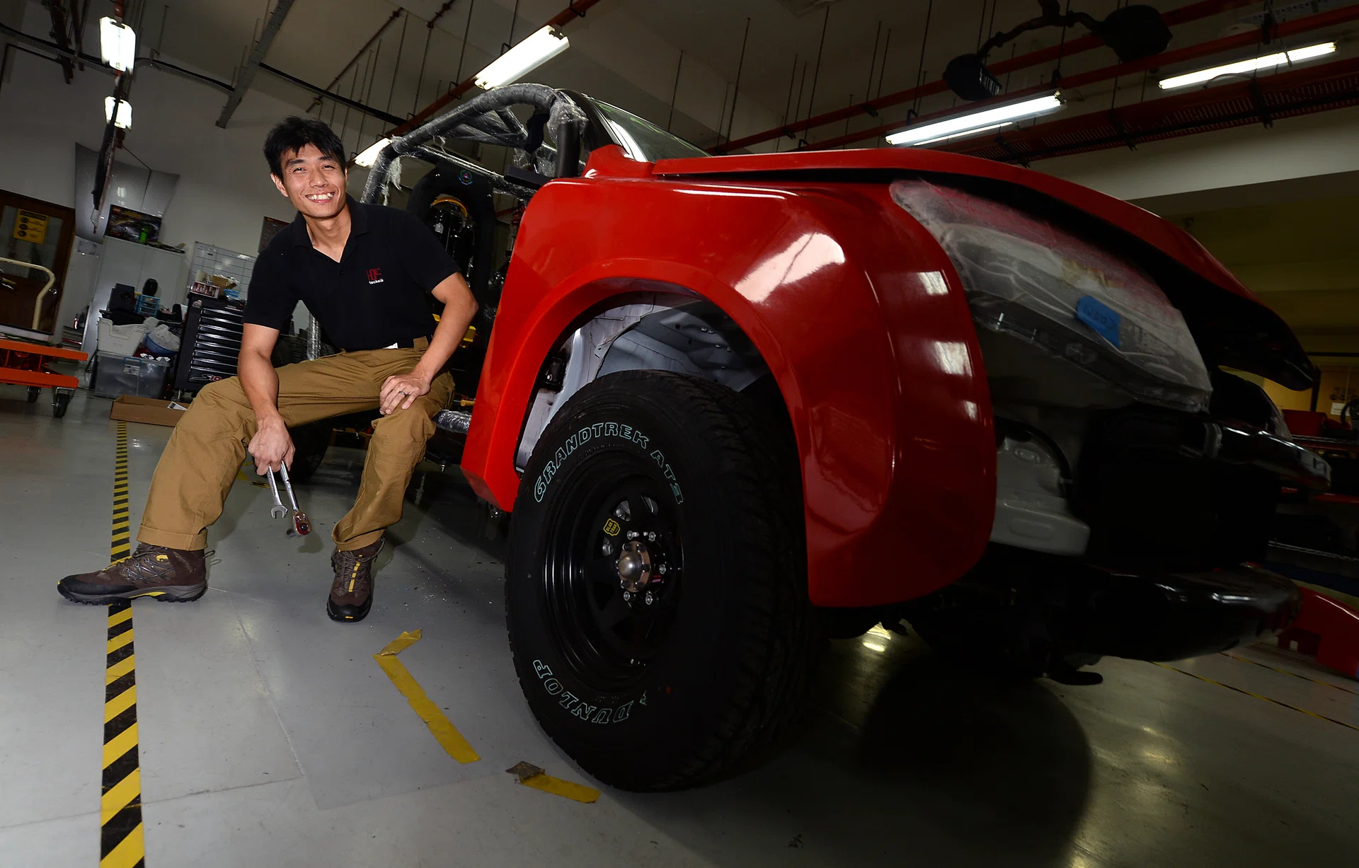 HARD WORK: Co-founder and director of Hope Technik, Mr Ng Kiang Loong, with a Red Rhino, a fire-fighting vehicle that his company helped to improve. 