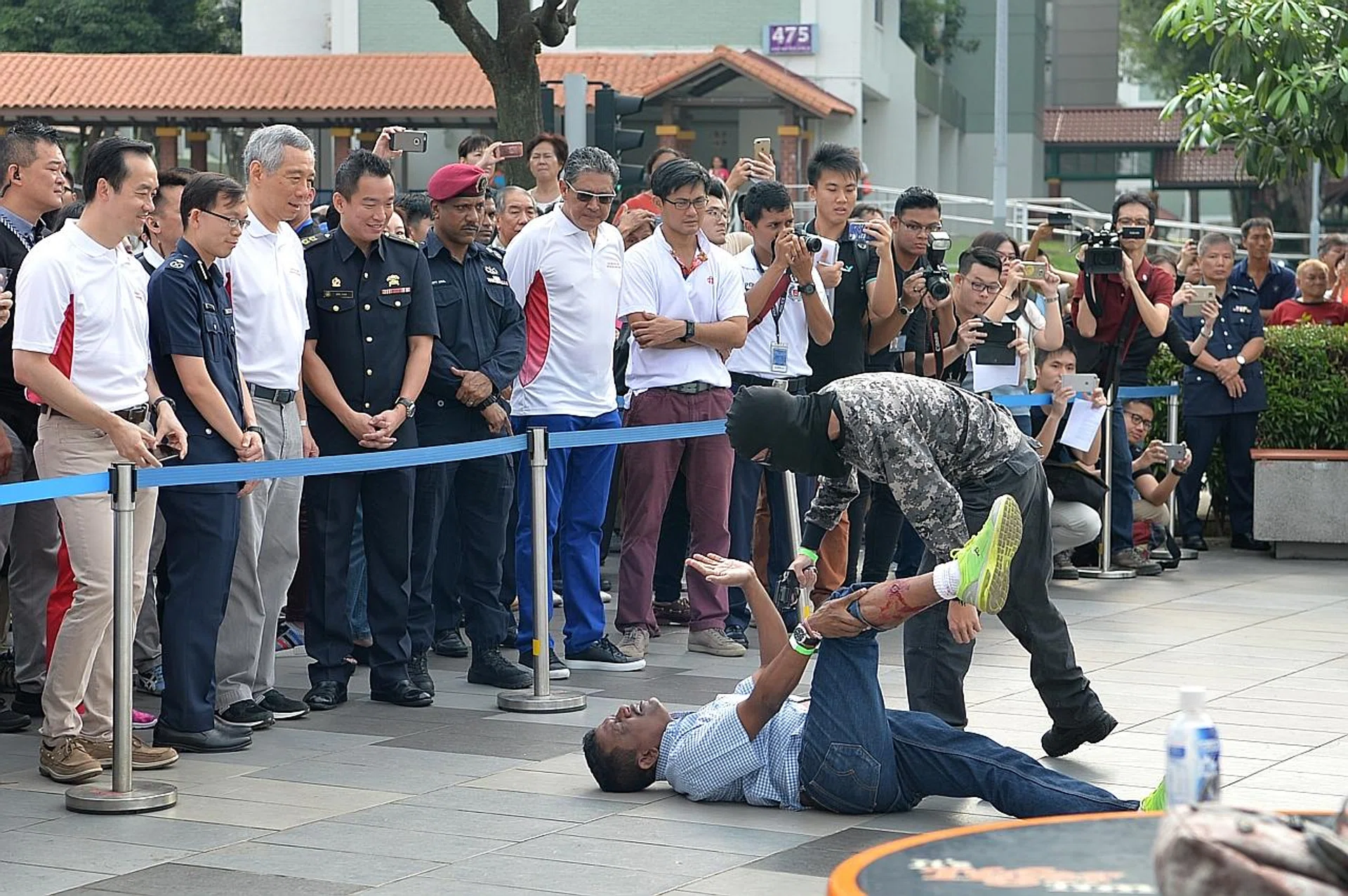 Prime Minister Lee Hsien Loong looking on as a simulated terror attack is carried out. 