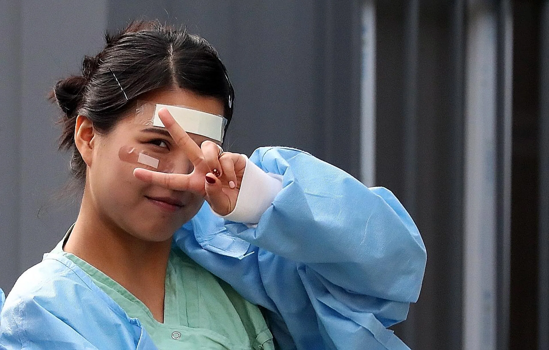 A nurse at Dongsan Hospital in coronavirus-hit Daegu with bandages on her cheeks and forehead allegedly due to rashes from wearing goggles for a long time.