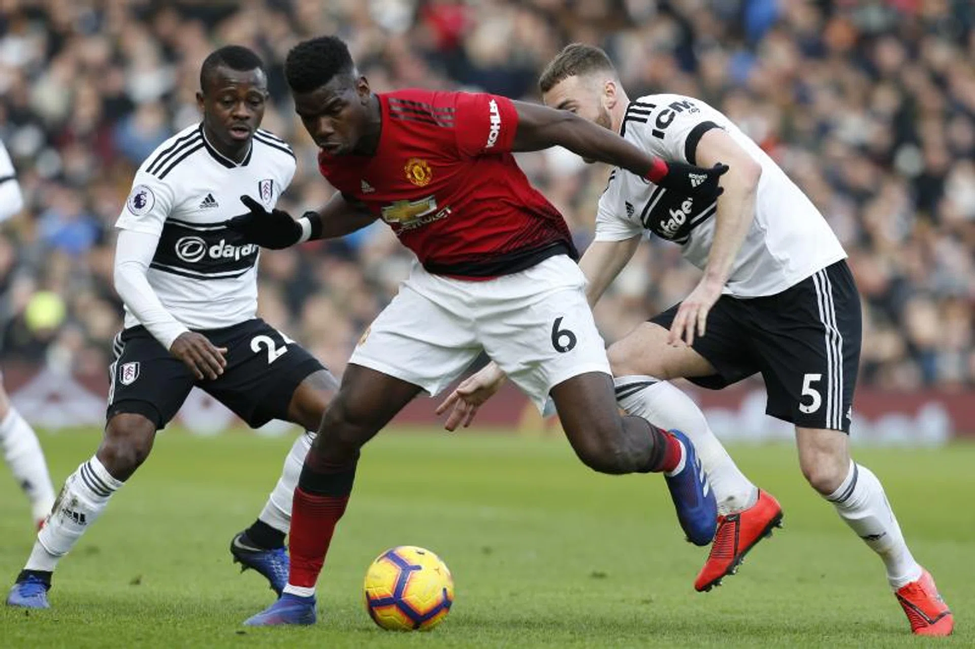 Manchester United's Paul Pogba fending off a challenge from Fulham's Calum Chambers.