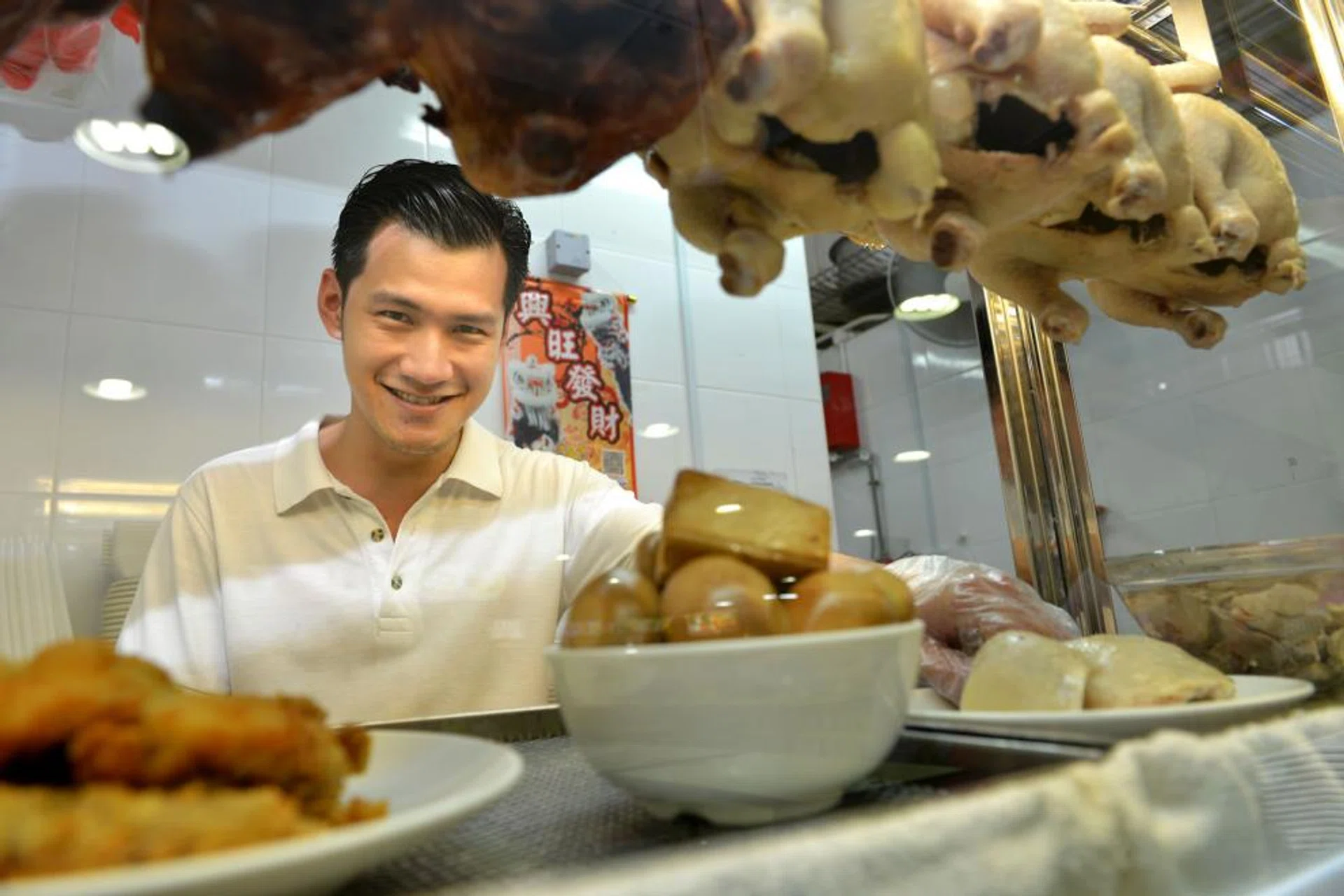 National University of Singapore business graduate Derrick Lee is running his own chicken rice stall. 
