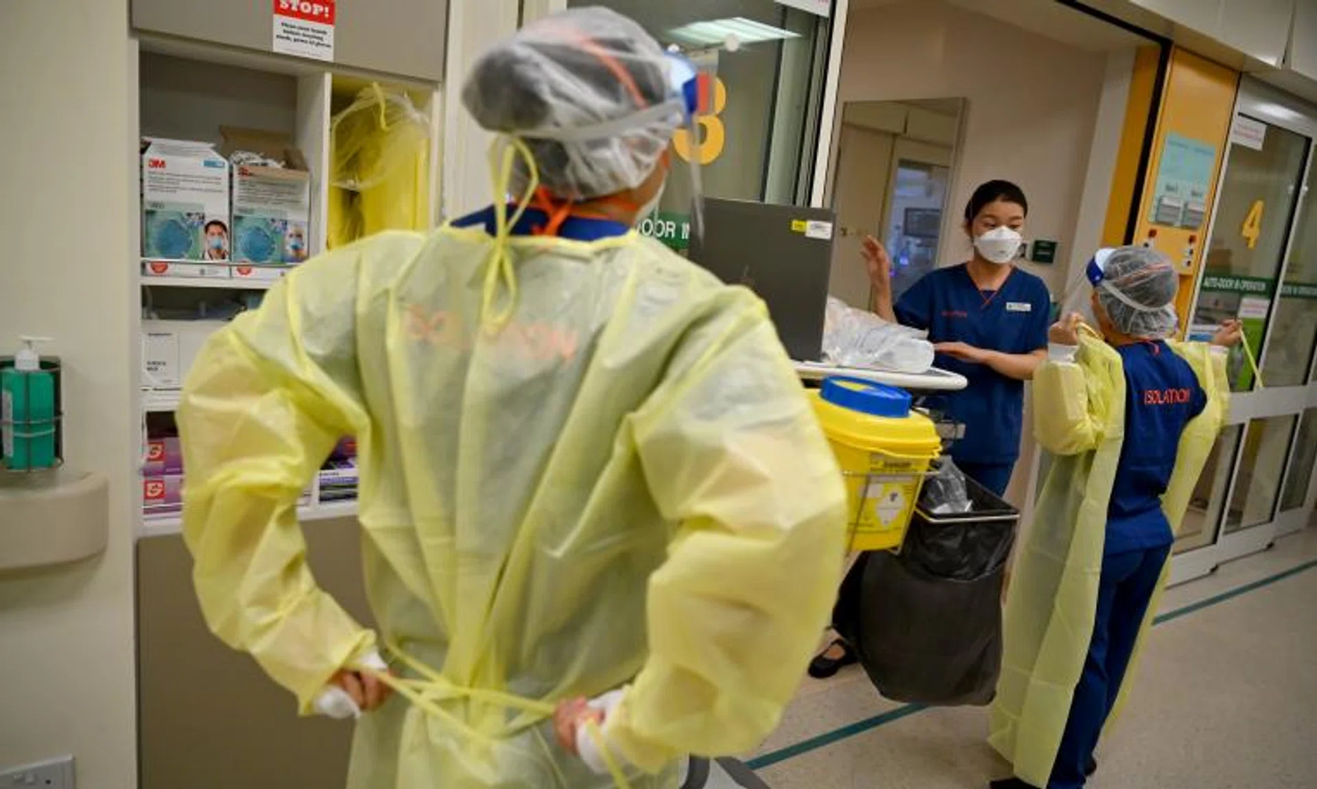Medical staff donning protective equipment at a Singapore General Hospital isolation ward in November 2021.
