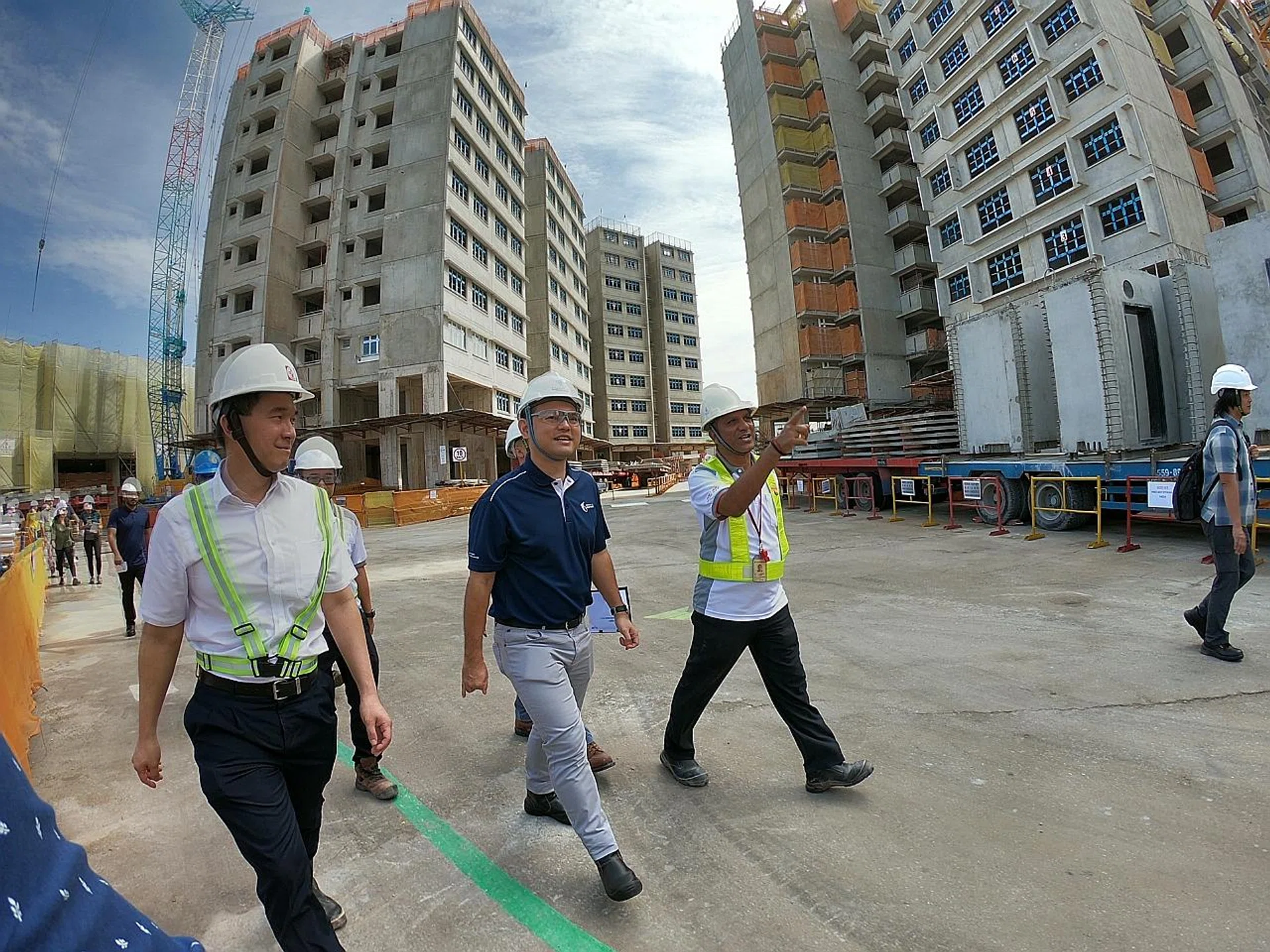 Minister of State for Manpower and National Development Zaqy Mohamad (in blue) on a visit to Sim Lian Construction's worksite in Bukit Panjang. 