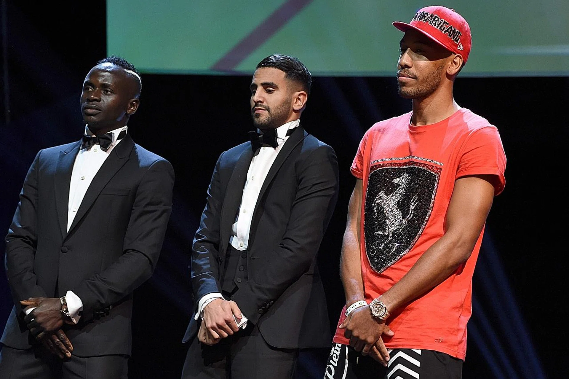 Pierre-Emerick Aubameyang (far right) wearing a T-shirt and baseball cap. 