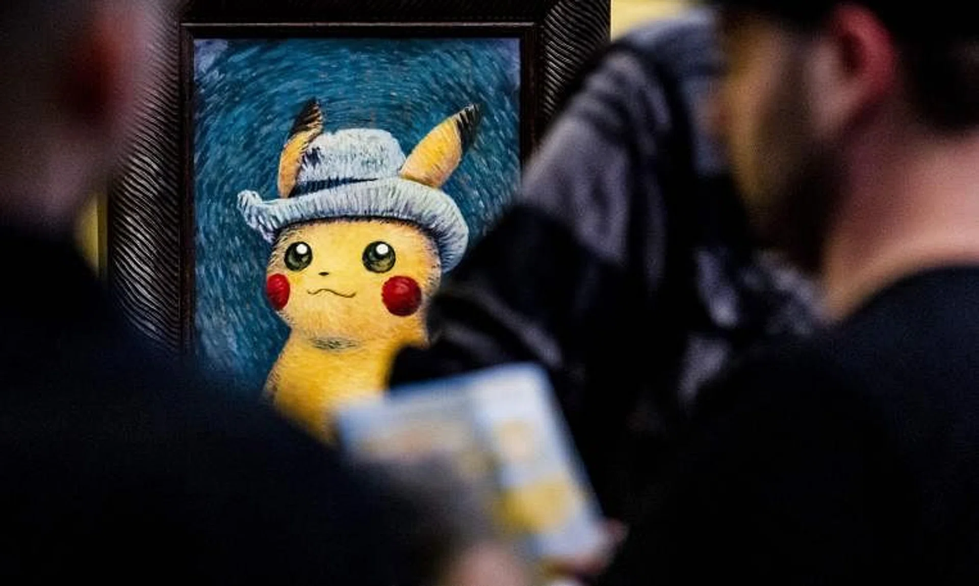 People look at paintings by artists inspired by the Pokemon at the Van Gogh museum in Amsterdam, on Sept 28.