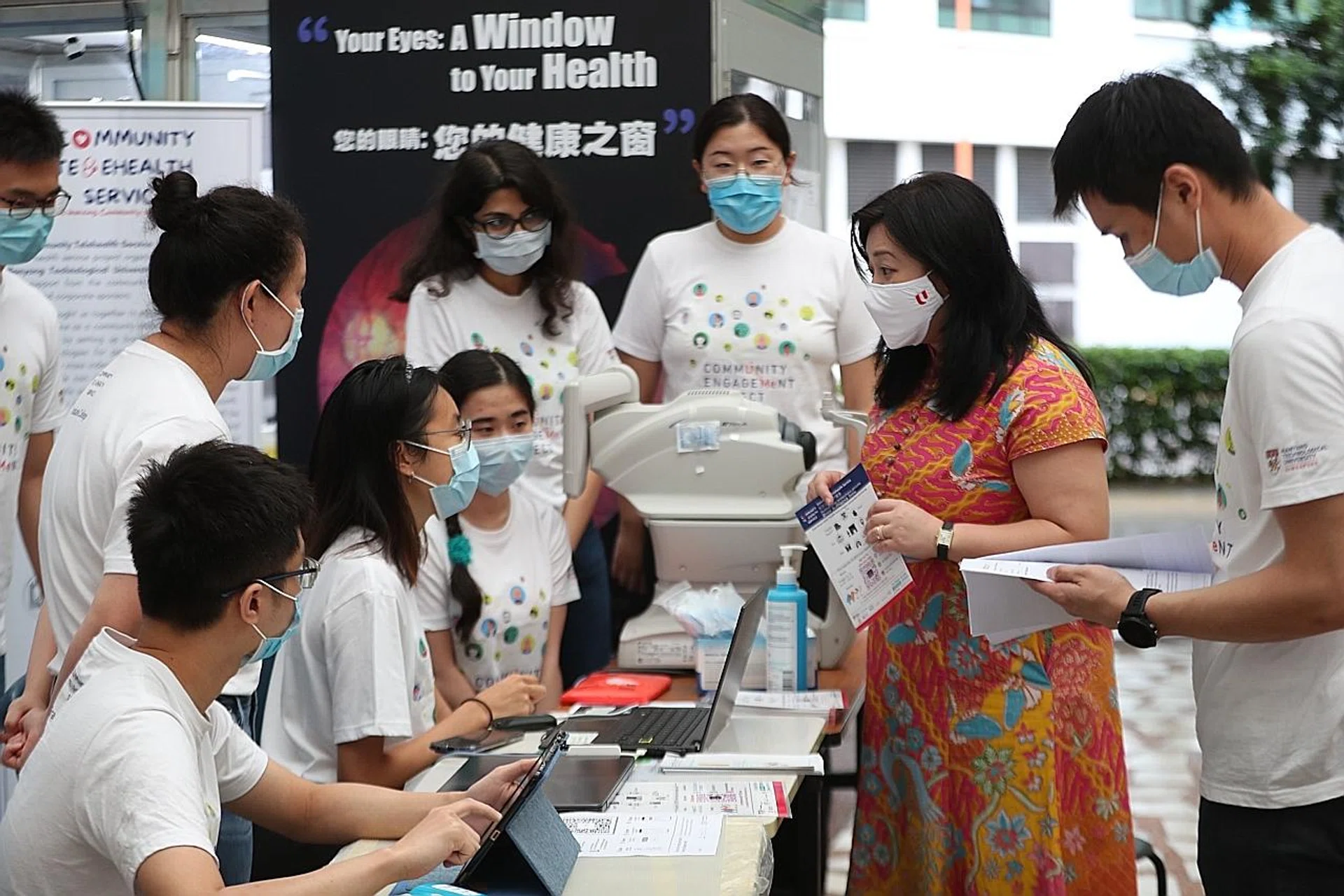 Ms Yeo Wan Ling (in dress), MP for Pasir Ris-Punggol GRC, viewing the telehealth screening booth at Punggol 21 Community Club. Up to 1,000 residents can register online.