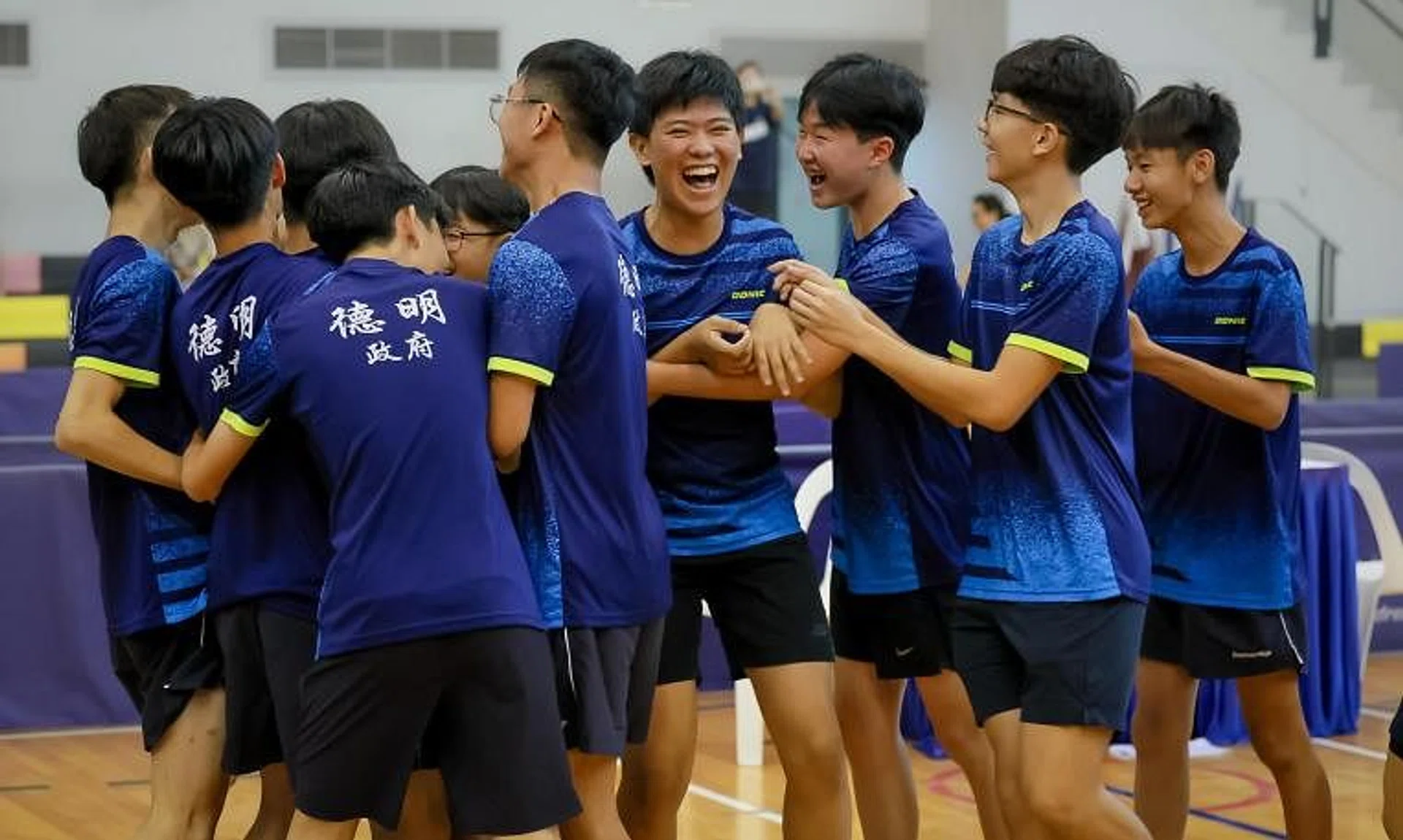 Players from Dunman High School celebrating after winning the B Division boys’ table tennis final against Raffles Institution.