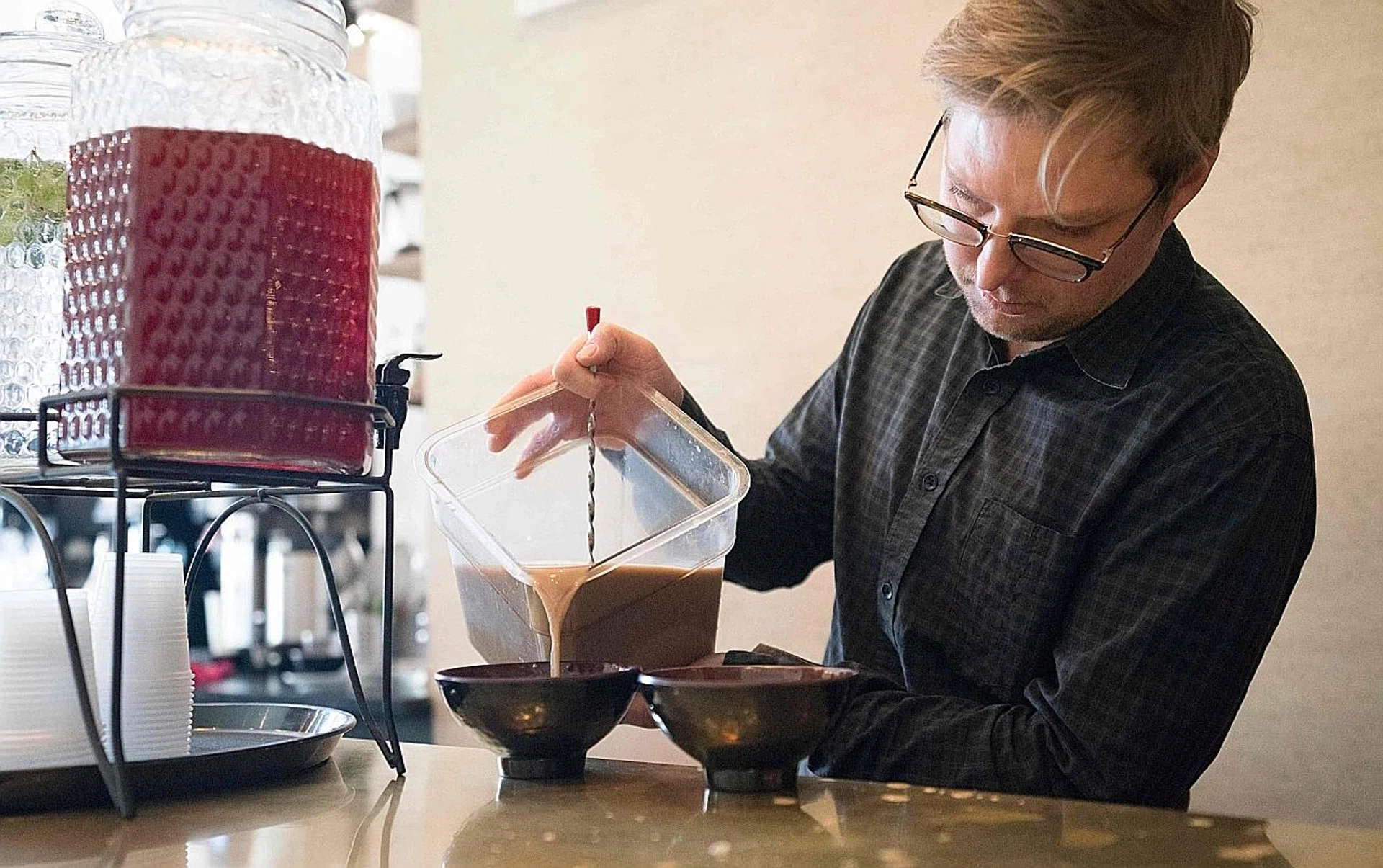 Mr Harding Stowe pouring kava into a bowl to be served at Brooklyn Kava.