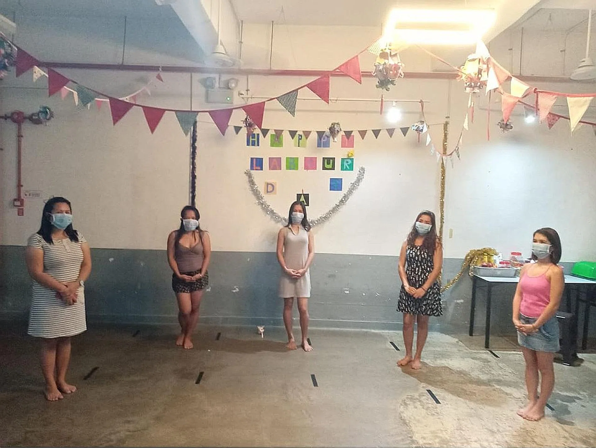 Domestic workers staying at a shelter run by the Humanitarian Organisation for Migration Economics celebrating Labour Day. Such facilities have had to limit the number of residents to ensure safe distancing.