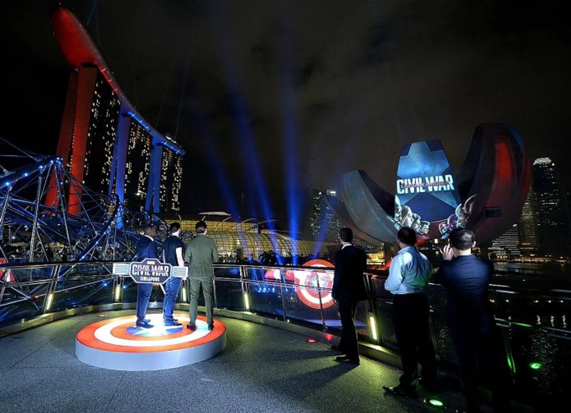 LIGHT IT UP: Above) The movie's stars, who included Chris Evans, Anthony Mackie and Sebastian Stan launching the #TeamCap light and fireworks display yesterday. 