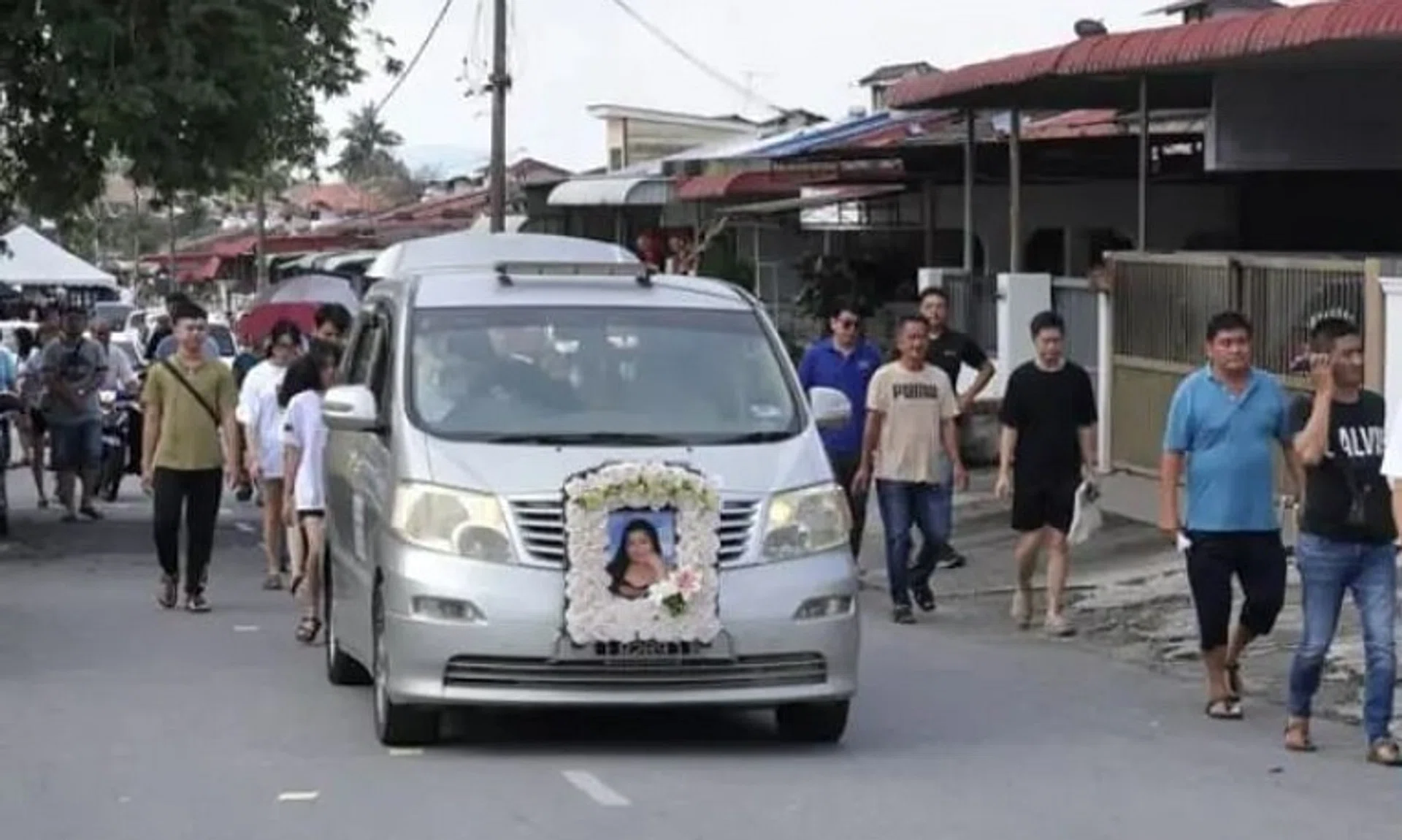 Family and friends sending off the hearse carrying the body of Ms Lee Zi Rou in Penang on Nov 17.