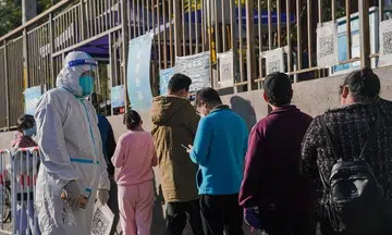 Beijing steps up Covid-19 measures as cases quadruple
