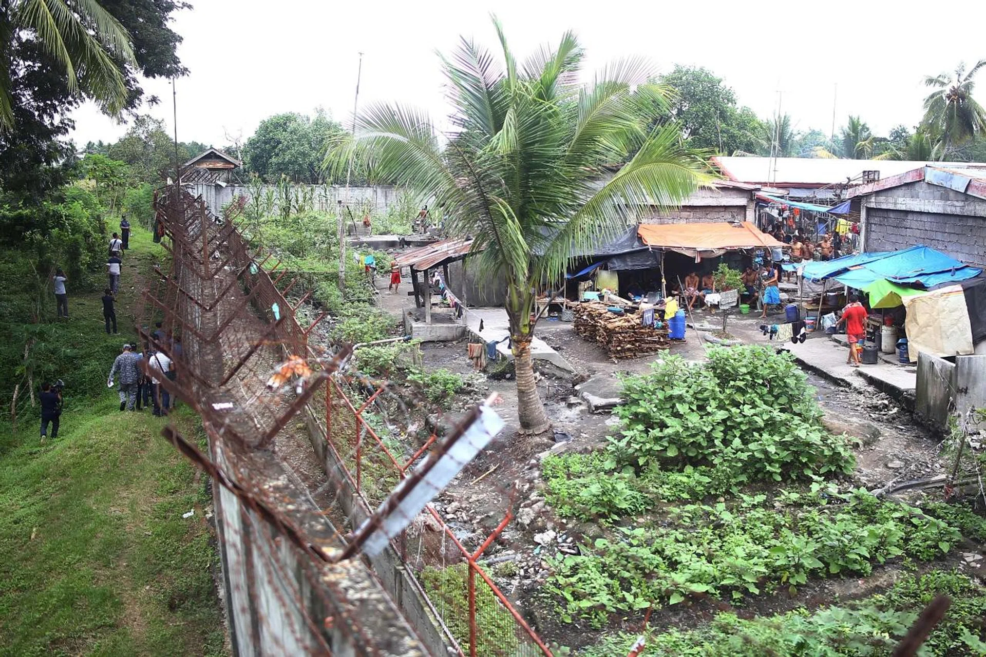 Prison officials (left) inspecting the fence of the jail. 