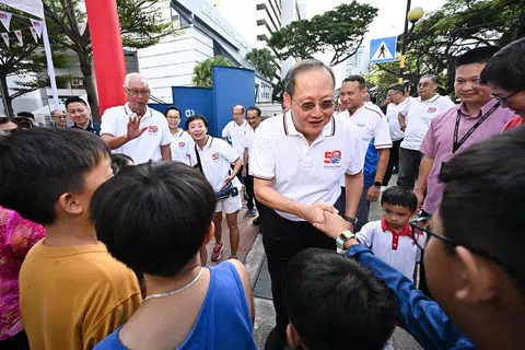 Manpower Minister Tan See Leng greeting residents at an event in Marine Terrace in April 2024. Behind him is Emeritus Senior Minister Goh Chok Tong and PAP new face Choo Pei Ling (next to ESM Goh).