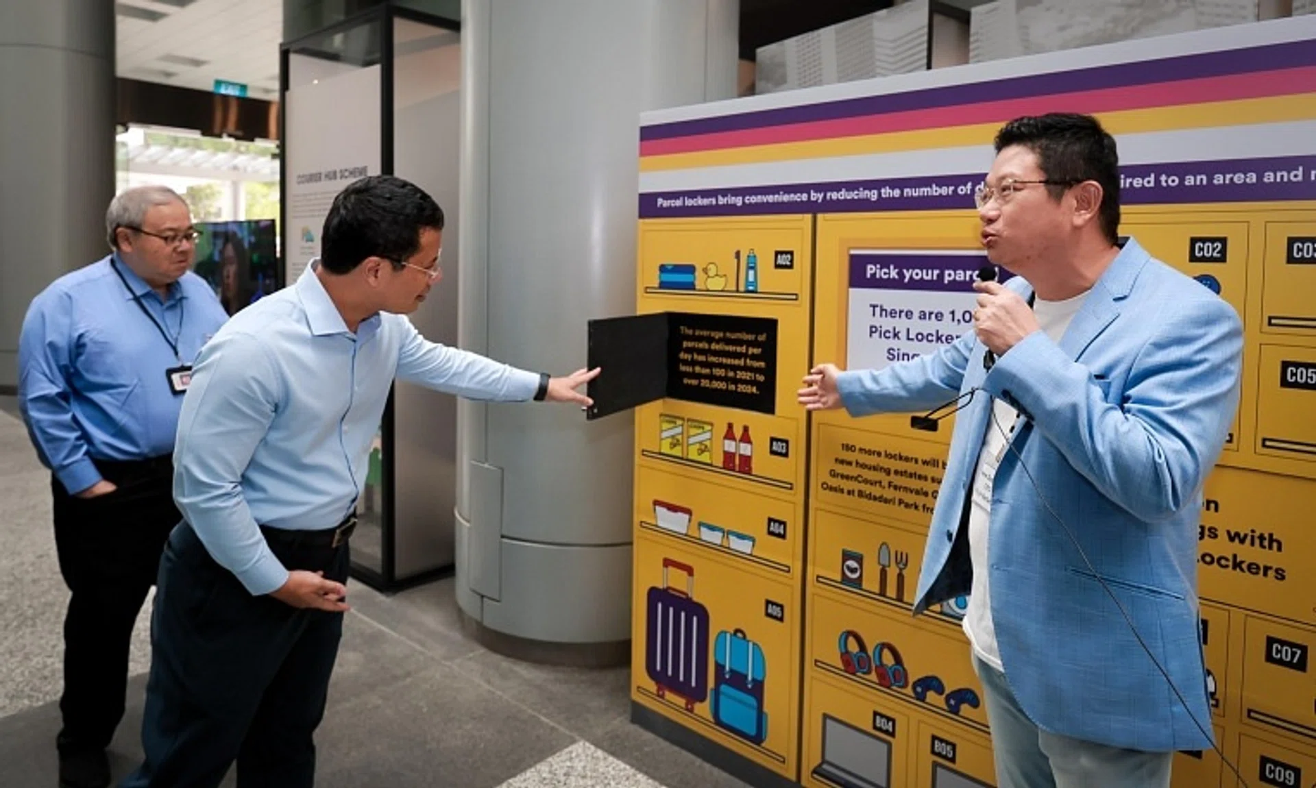 National Development Minister Desmond Lee (left) at a presentation by Pick Network CEO New Soon Tee during an exhibition launch at the URA Centre on Nov 15.