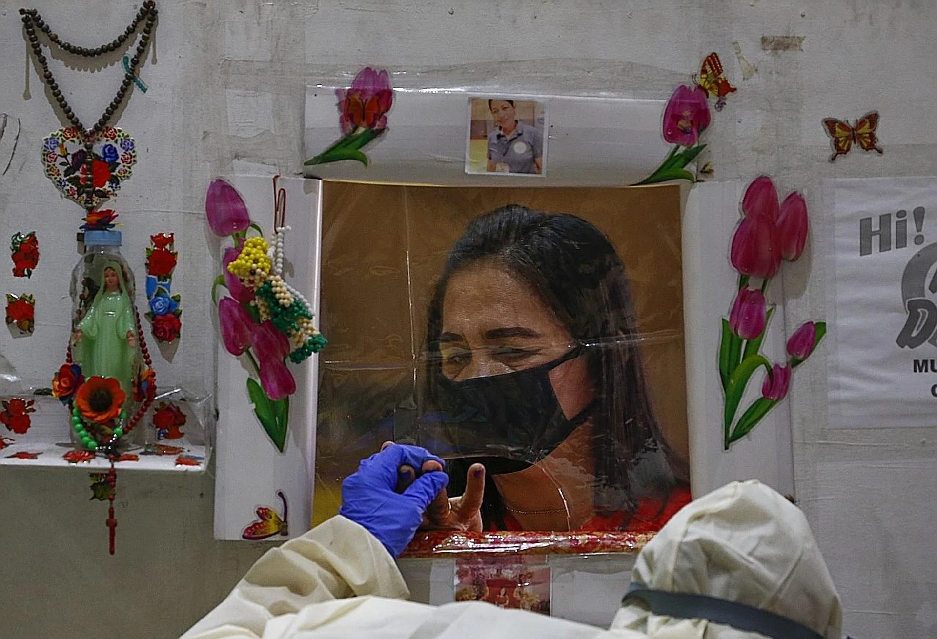 A woman in a face mask submitting a blood sample at a coronavirus testing centre in Pasig City, Metro Manila, the Philippines. 