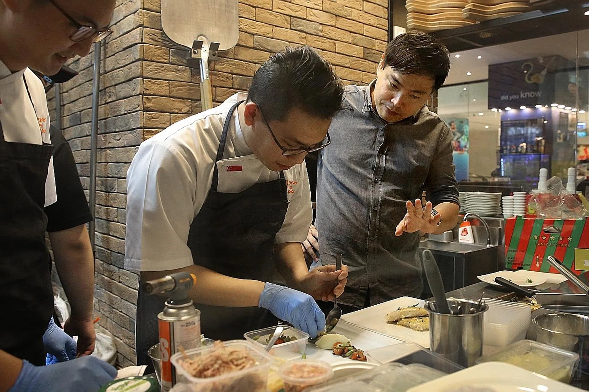 Mr Collin Ho (far right) and Unilever Food Solutions' chefs recreate a pan-seared haddock dish originally from Collin's menu. 