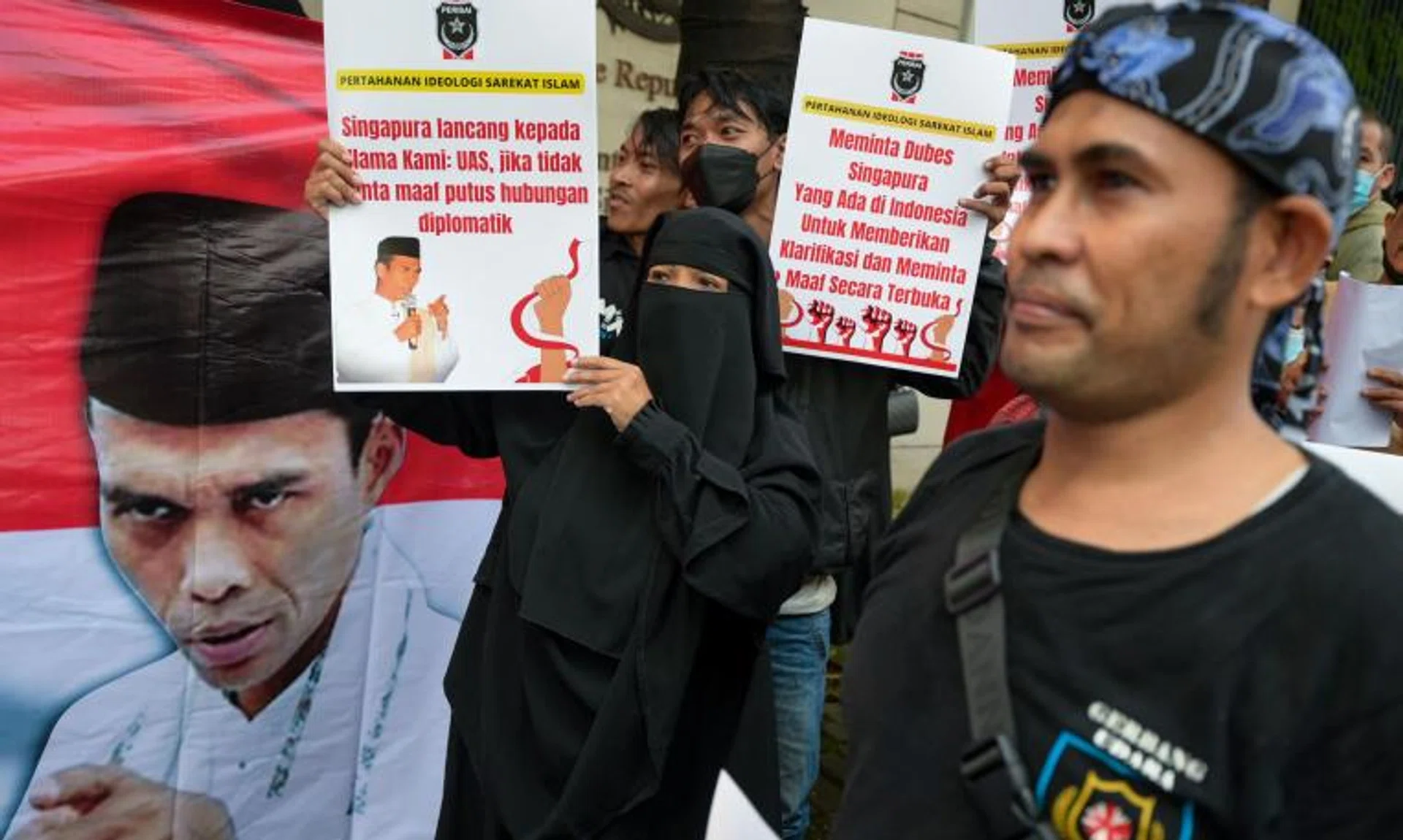 Muslim preacher Abdul Somad's supporters hold a protest in front of the Singapore embassy in Jakarta on May 20, 2022.