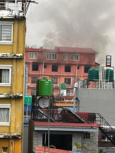 Thick smoke began billowing from the building opposite Ms Anna Yeow's hotel in Pokhara on Sept 9.