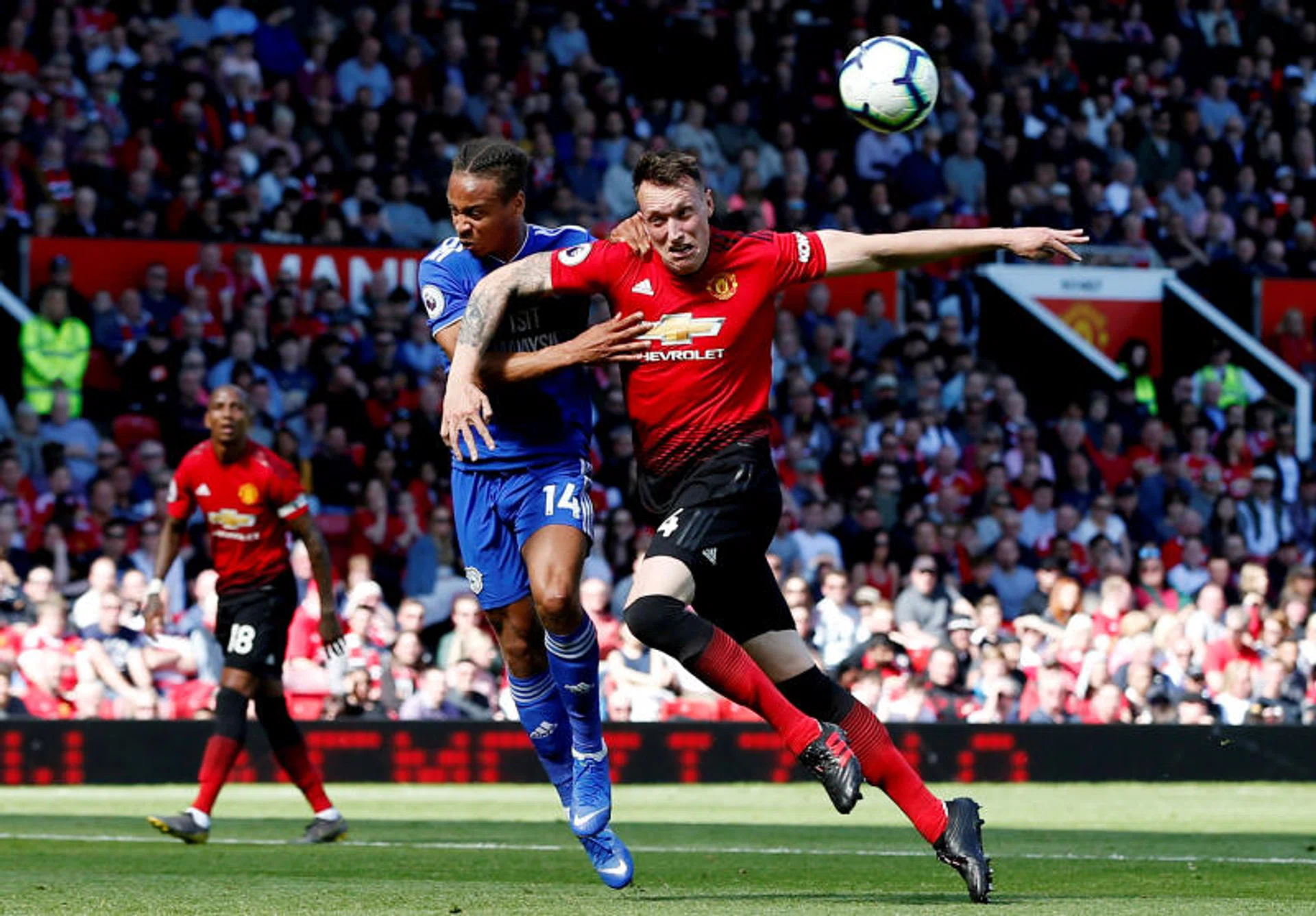 Manchester United's Phil Jones challenging for the ball with Cardiff City's Bobby Reid.