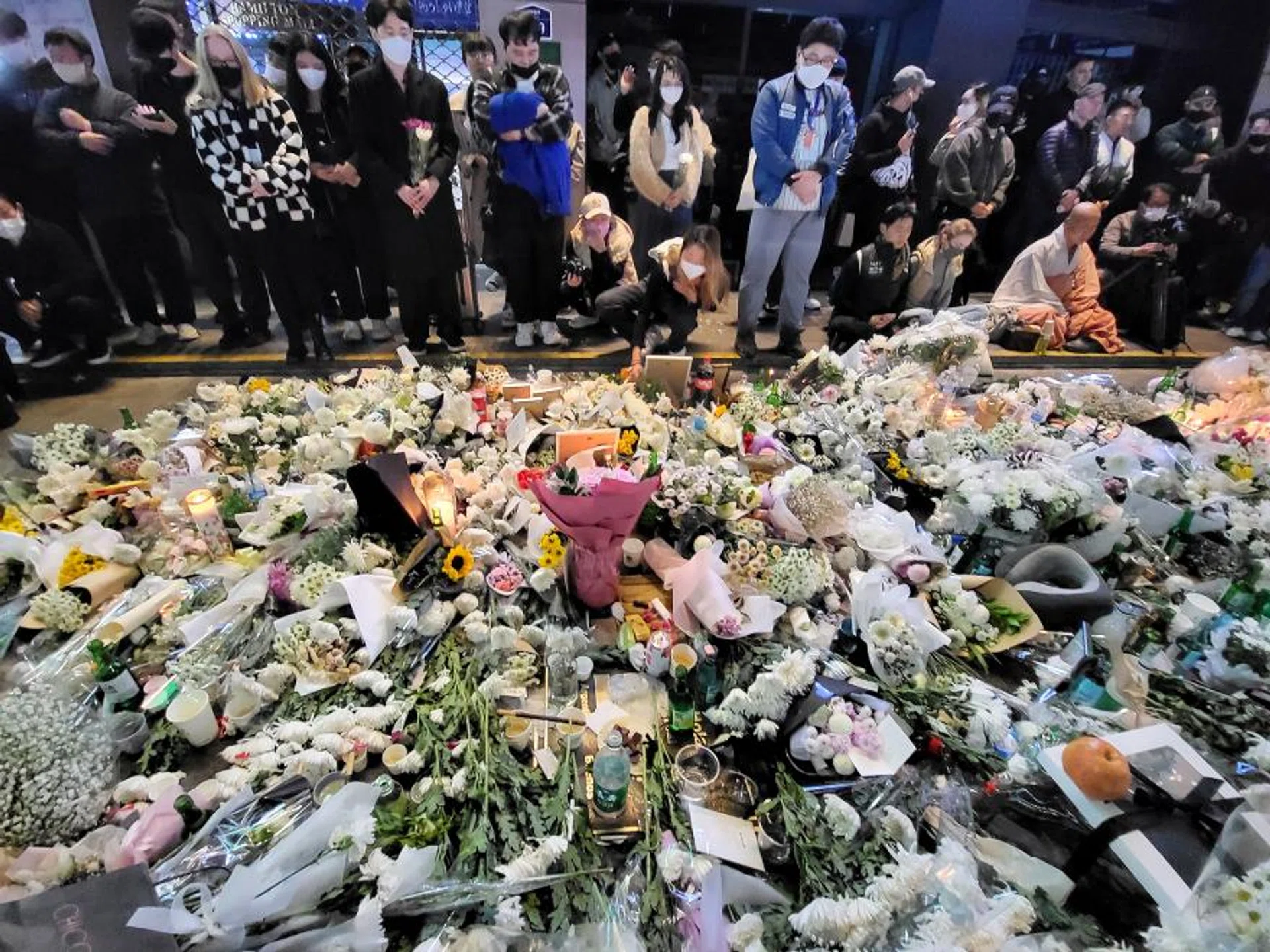 Mourners grieve at an impromptu memorial in the Itaewon neighbourhood of Seoul on Monday, Oct 31, 2022, in honour of the victims of the Halloween disaster. 