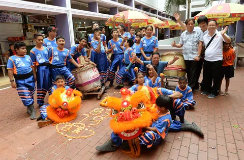 Young multi-racial lion dance troupe perform at Bukit Merah celebrations
