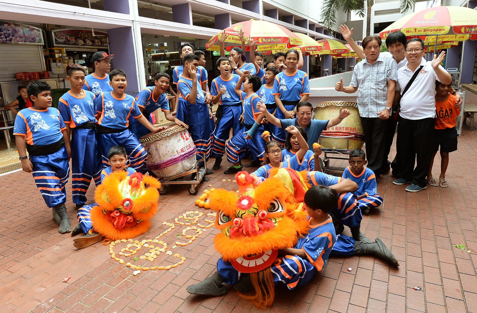 FRIENDS: Norahimah Haja, Chua Tian Yi and Muhd Fitri Mohd Noor are part of a volunteer lion dance troupe (above) made up of teenagers from different races.