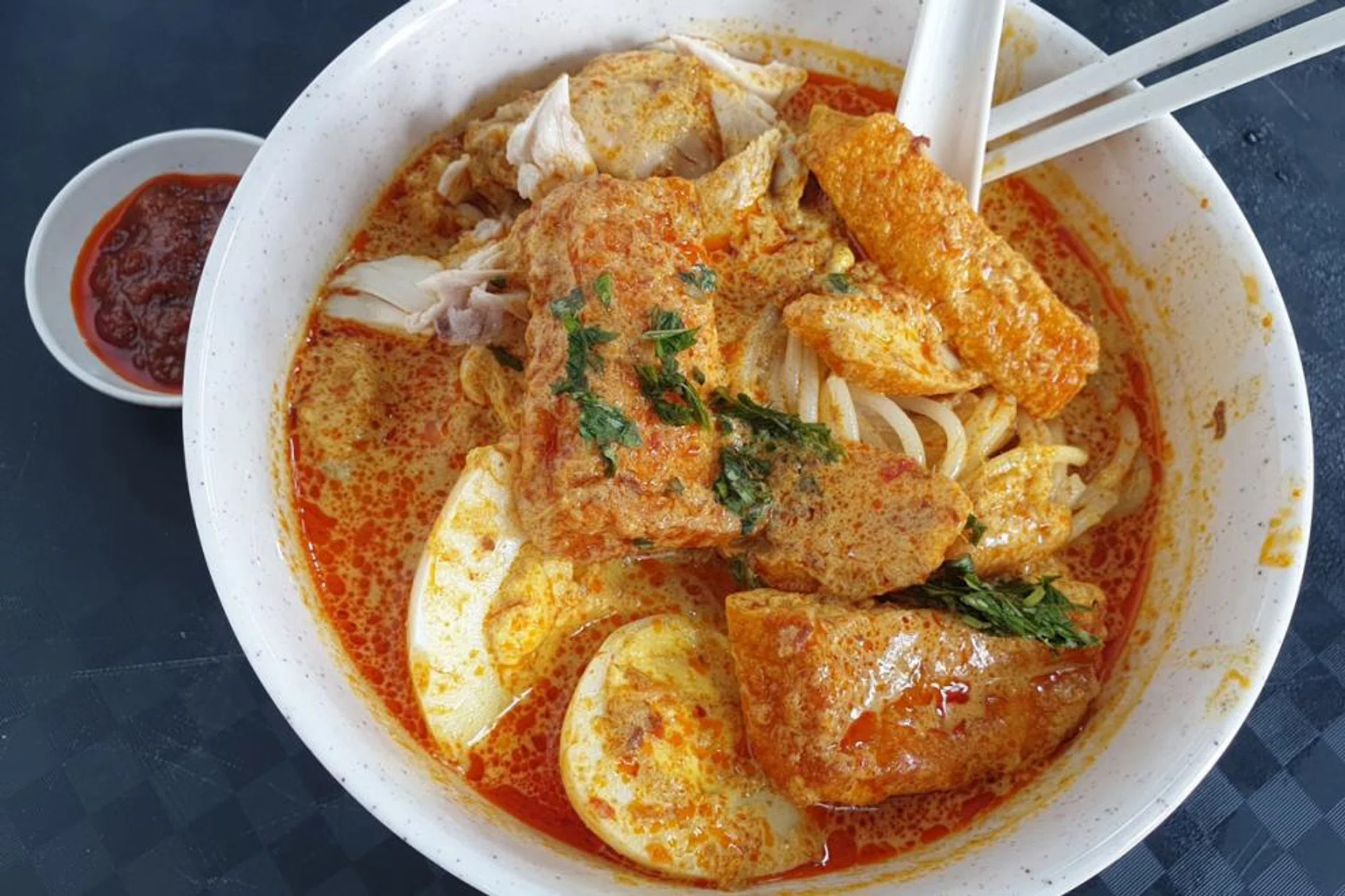 Mr Koh Seng Choon, is the founder of Dignity Kitchen in Boon Keng Road, a foodcourt managed by people with disabilities who whip up local favourites like laksa (above), kolo mee and claypot rice. 