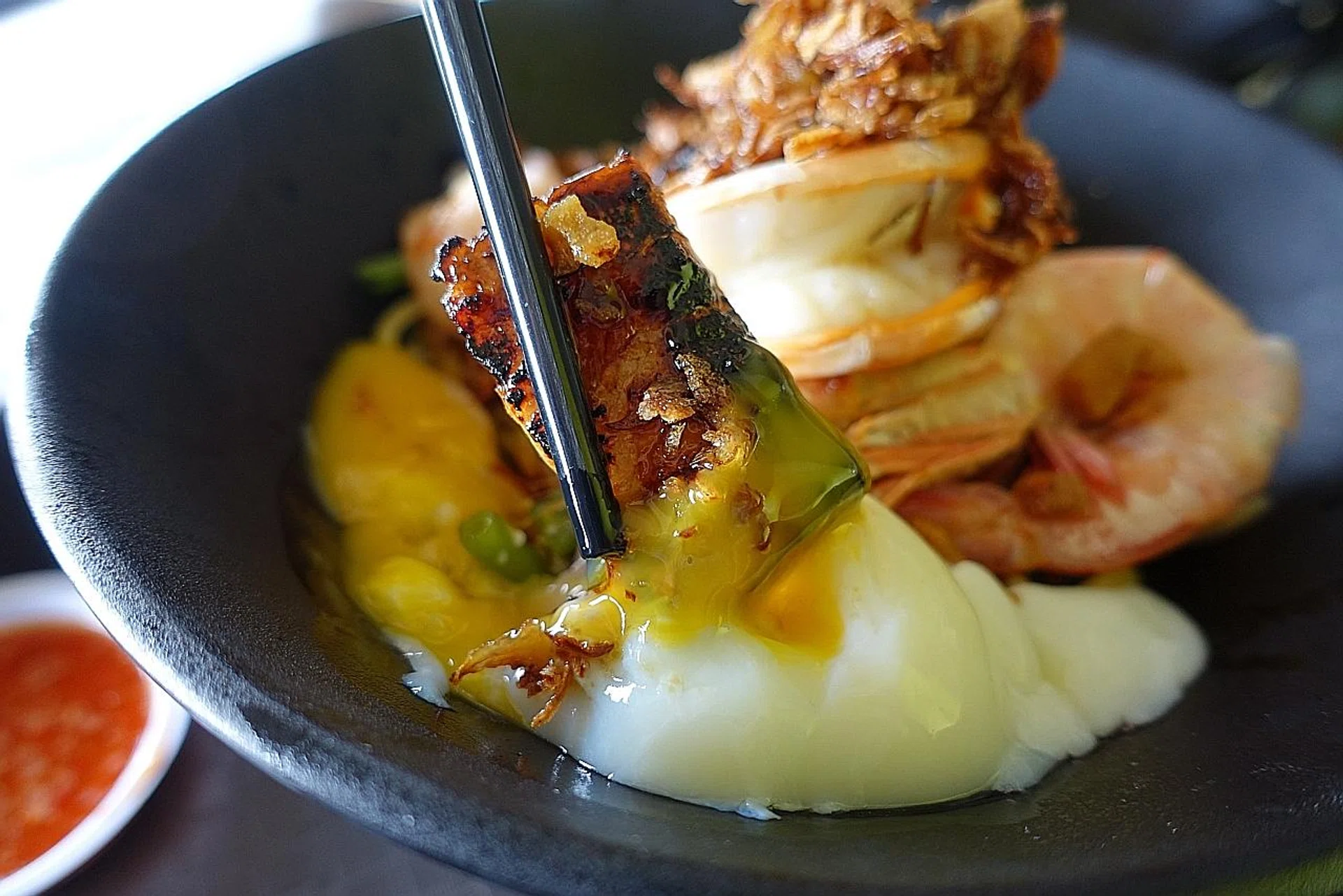 (Above) Dip the char siew into the egg yolk.
