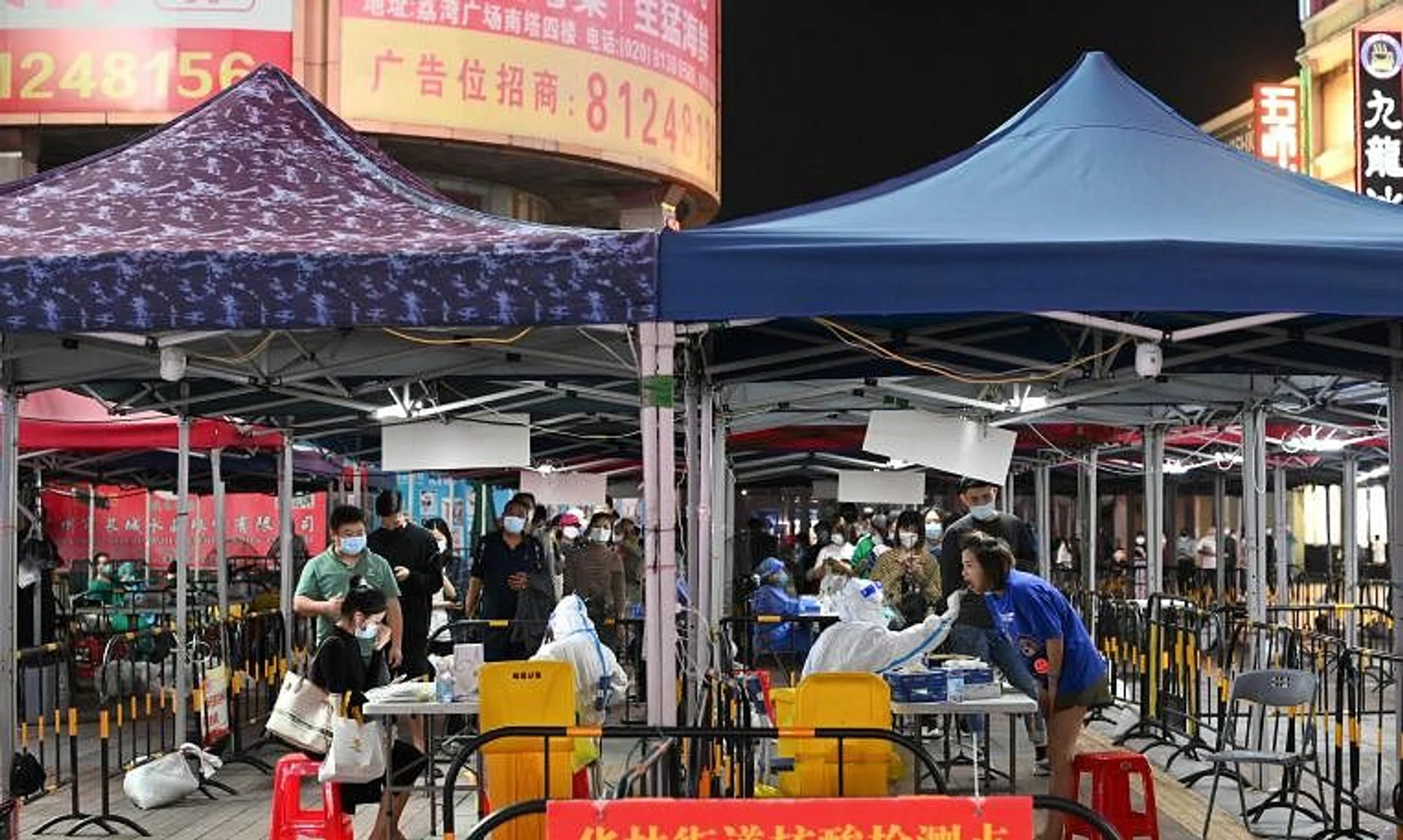 People line up to take nucleic acid test for Covid-19 at a makeshift testing site in Guangzhou, Guangdong province, China.