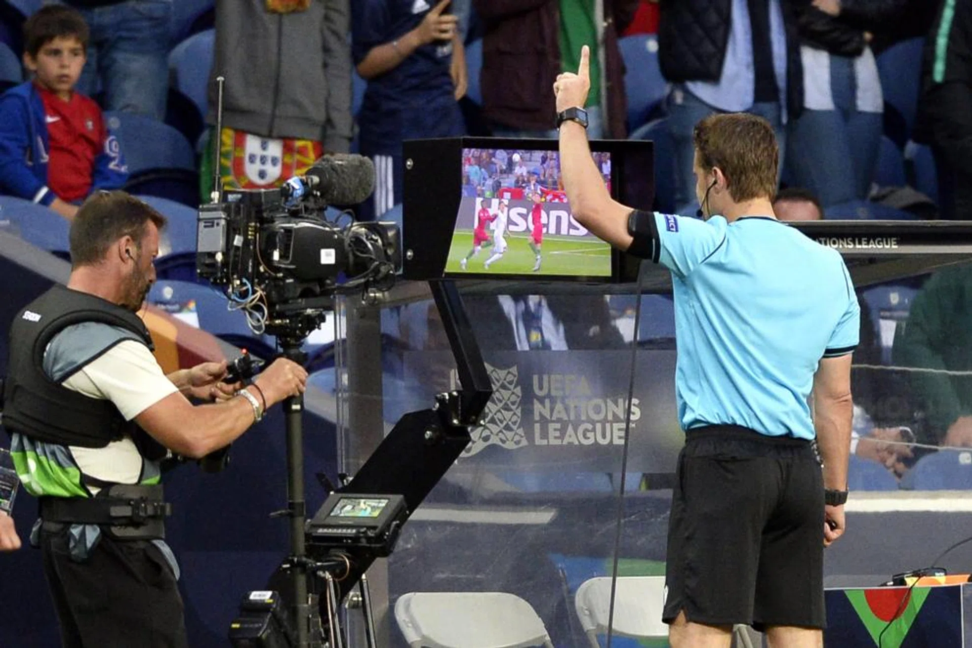 German referee Felix Brych looks at a replay of the video assistant referee (VAR) during the Nations League match between Portugal and Switzerland.