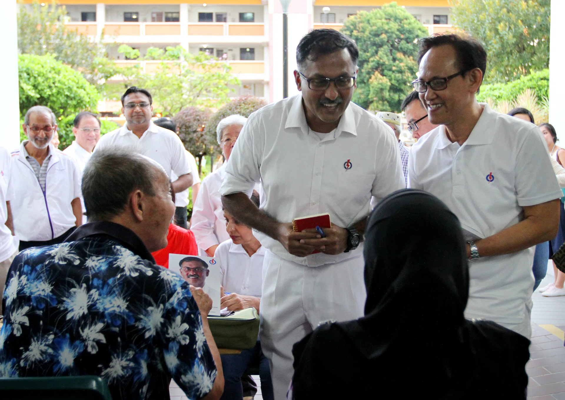 HEAD TO HEAD: (Above) PAP candidate K. Muralidharan Pillai with Bukit Batok residents yesterday. SDP candidate Chee Soon Juan during a walkabout in Bukit Batok on March 13. 
