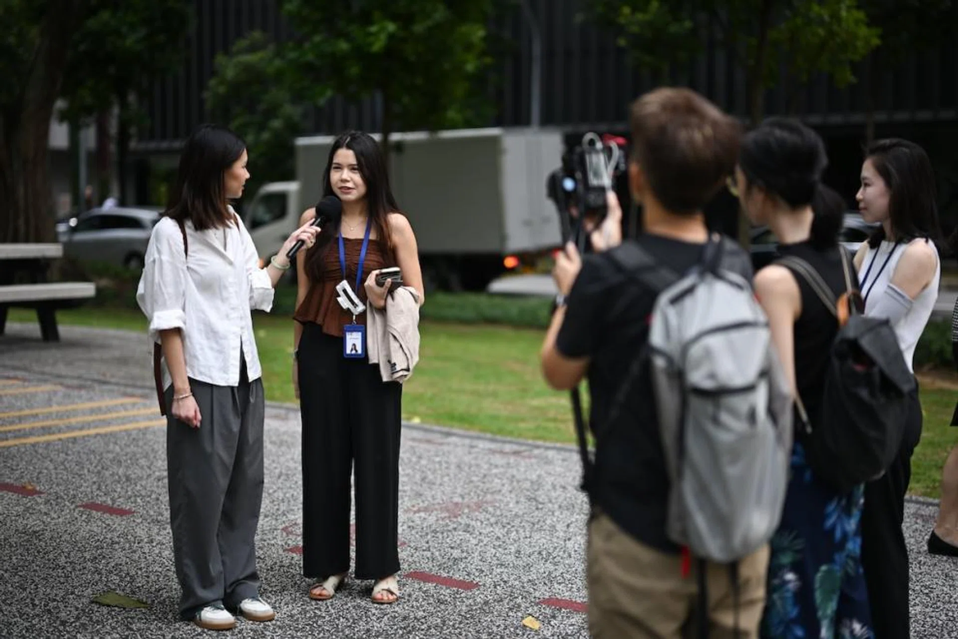 The writer interviewing Ms Jane Fernandez, 23, a market analyst, near Tanjong Pagar MRT station on Dec 17, 2024