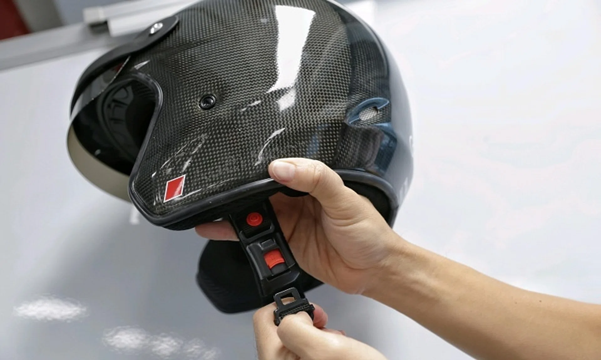 A helmet with a quick-release mechanism. Updated testing standards will allow motorcycle helmets with such a mechanism to be approved in Singapore.